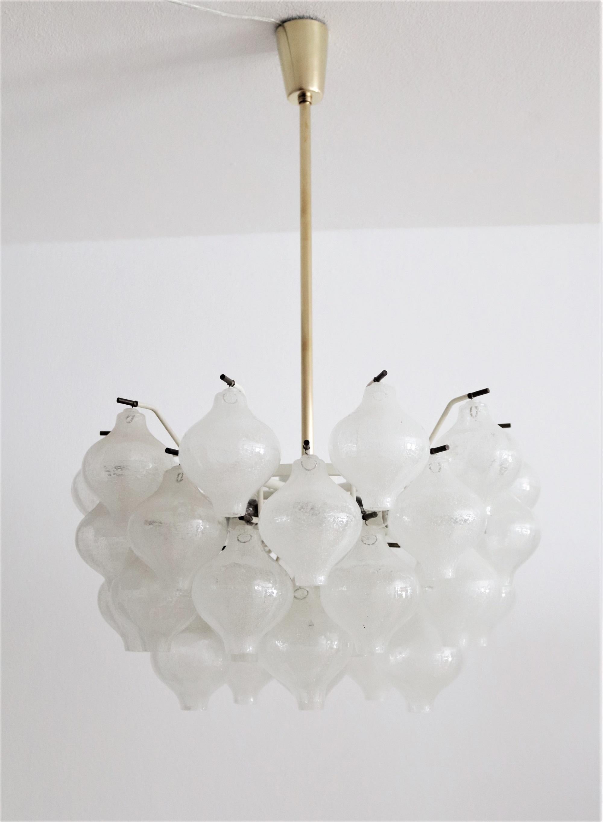 A gorgeous modernist brass and Murano glass chandelier pendant light from the 1960s. 
Called 'Tulipan', designed and manufactured by Kalmar Vienna, Austria. The glasses have been manufactured at that time in Murano/Italy.
The chandelier has 41 hand