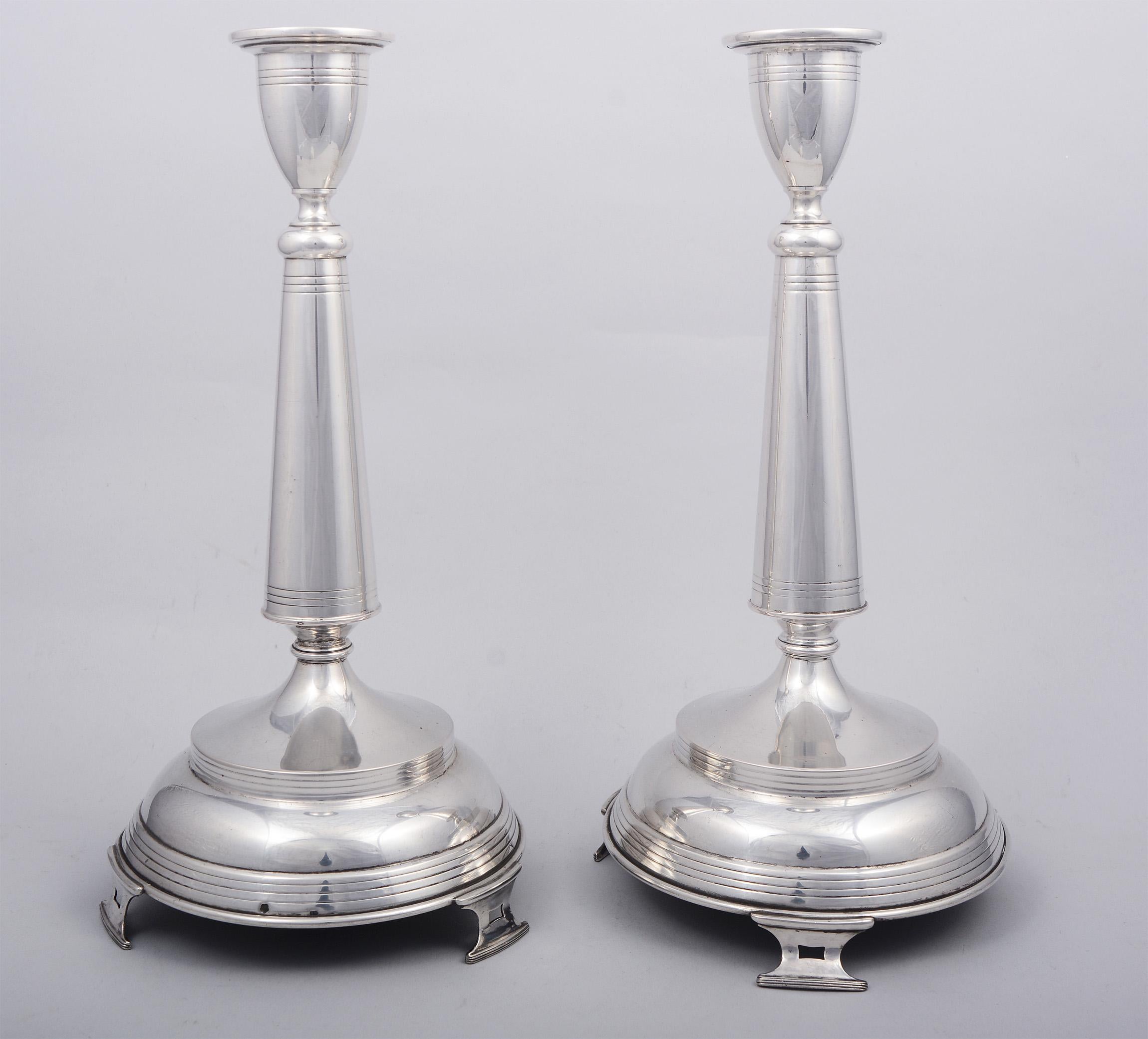 Pair of Austro-Hungarian 800 silver candlesticks with a Vienna Secessionist influence. These have a Vienna assayers hallmark. They are slightly bent at the narrow portion above the base causing the top half of each of these to lean a little. There