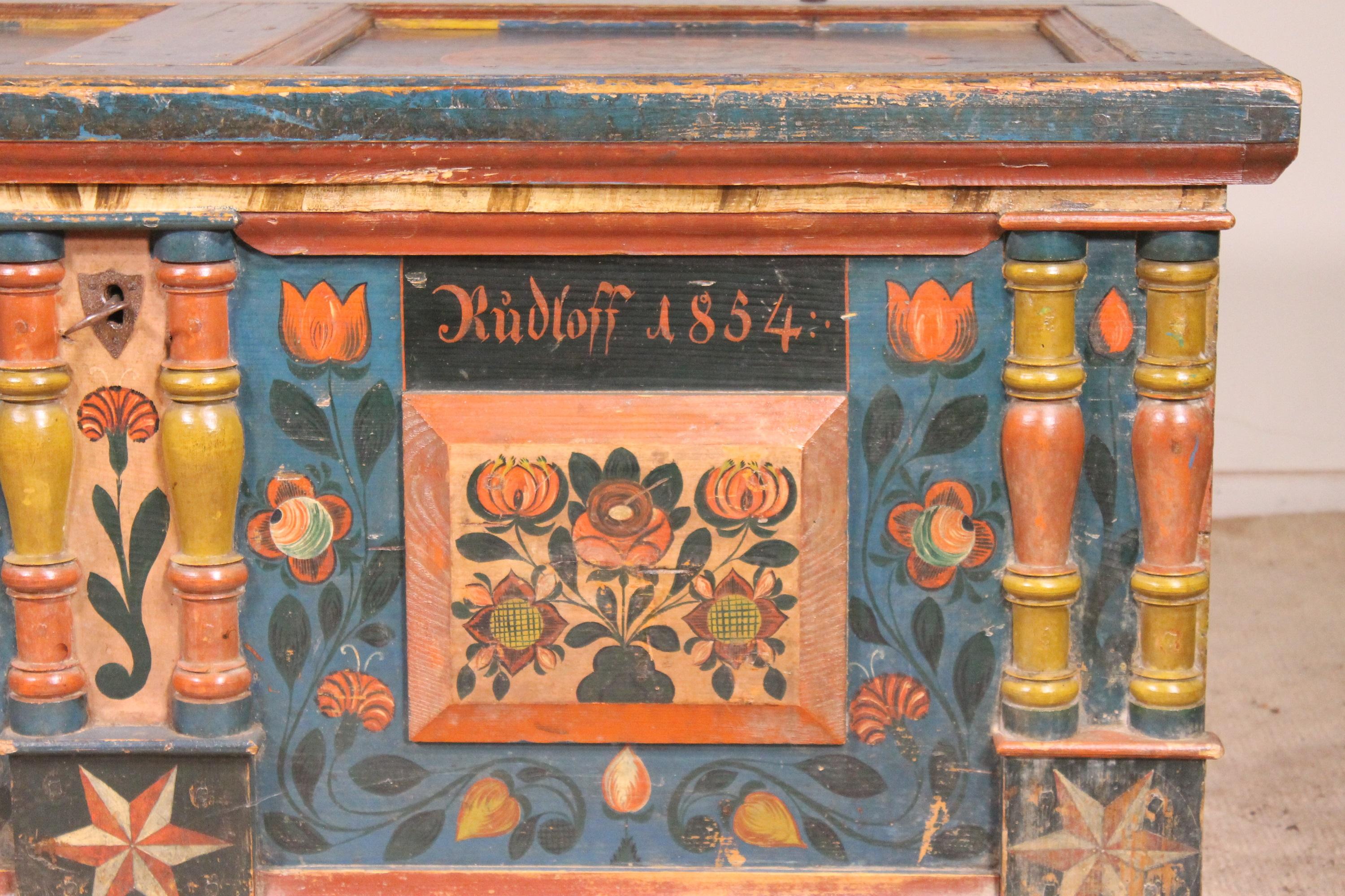 Superb Austrian wedding chest dated 1856 in polychrome wood decorated with flowers, stars and bouquets of flowers
We can find the names of the two newlyweds on the front with the presence of flowers symbolizing marriage

The chest opens into a