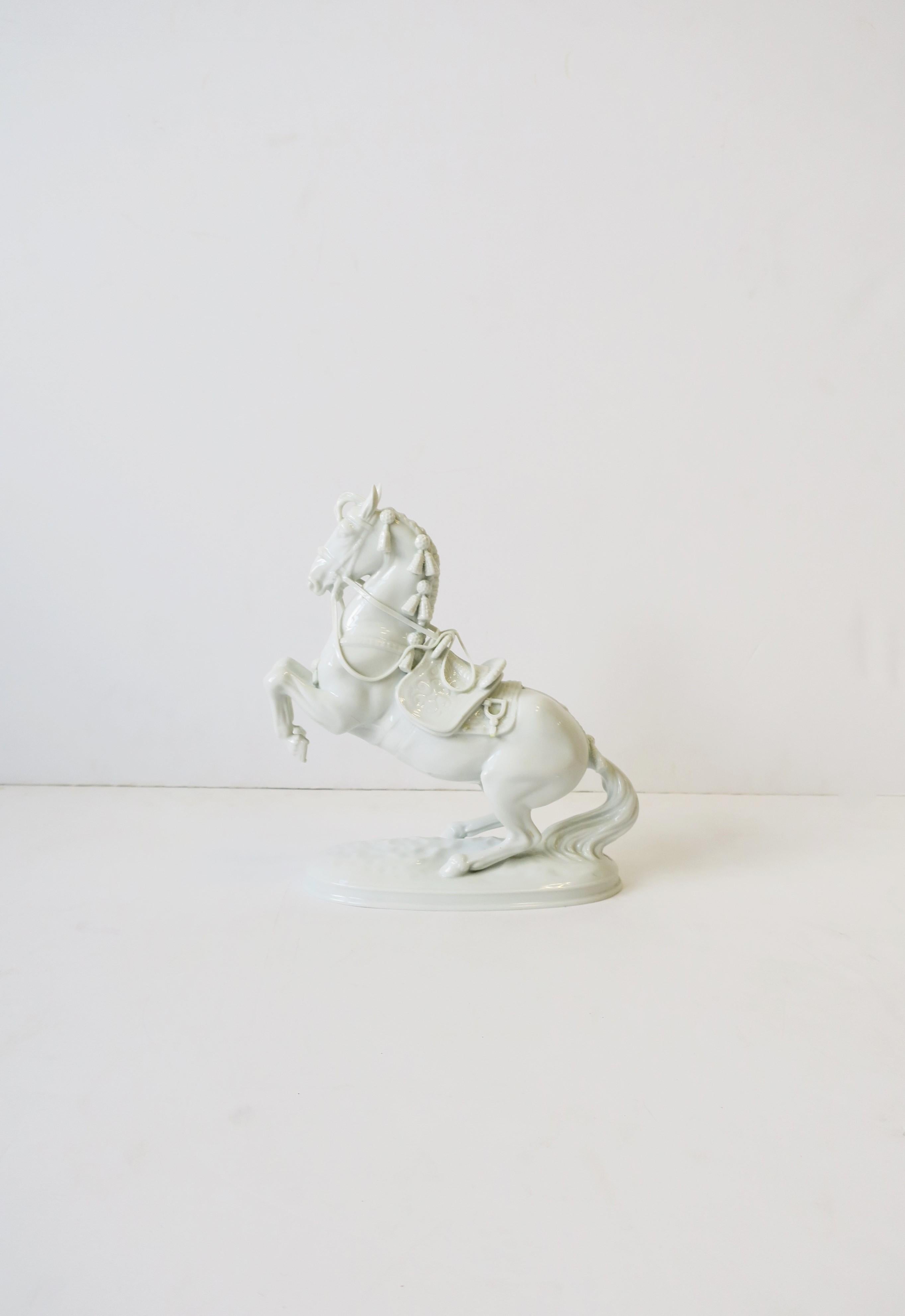 A beautiful majestic white porcelain equine horse sculpture decorative object, circa mid-20th century, Austria. Piece is comprised of many fine details including its ears, main, saddle, reins, tail, hoofs, etc. Piece is marked on bottom with