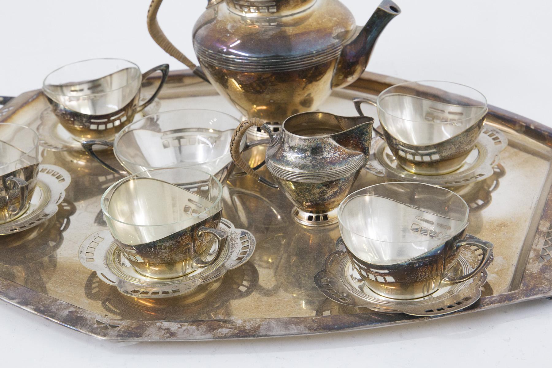 Austrian Viennese tea set dating back to the early 1900s manufactured by Argentor-Werke Rust & Hetzel. 
The service consists of 6 cups with their respective under-glasses, a teapot and milk jug. Finally, the service is completed by a tray. There