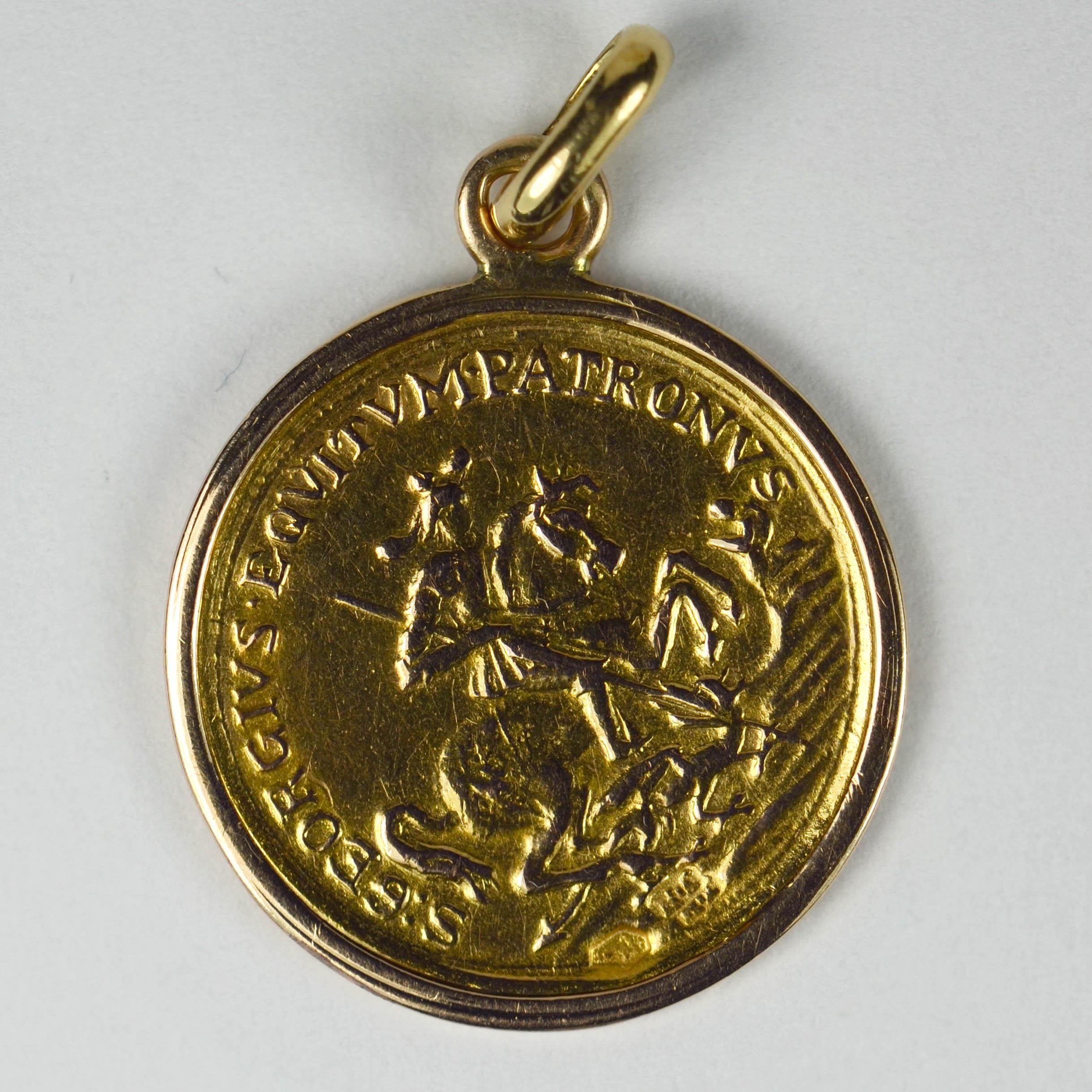 An 18 karat (18K) yellow gold charm pendant designed as an Austrian gold ducat set within a rose gold frame.

The coin depicts Saint George on a horse defeating the dragon with the words 'S. GEORGIUS EQUITUM PATRONUS' (St. George, Patron Saint of