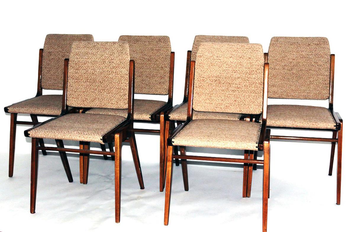 This set of six dining chairs in the style of Roland Rainer was designed by Wiesner-Hager and features solid wood frames with the original upholstery.