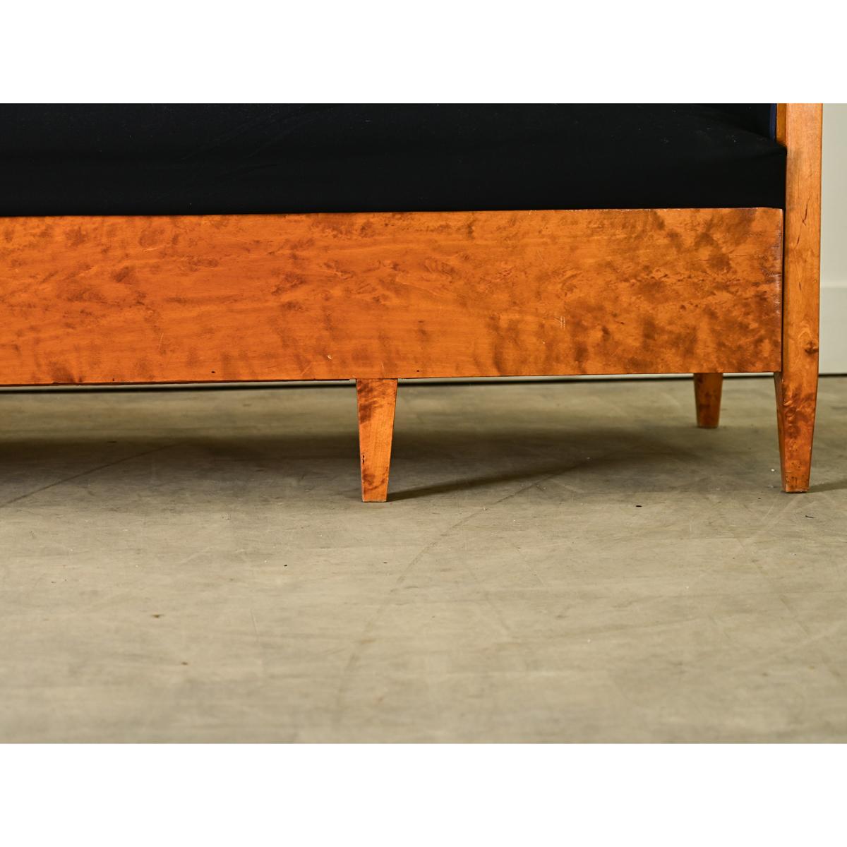 A fabulous Biedermeier style settee from 19th century Bavaria. The settee is made from exceptionally beautiful, solid maple. Some areas have a striped appearance to the grain. This is known as “tigering”. The sofa’s back has a central pointed