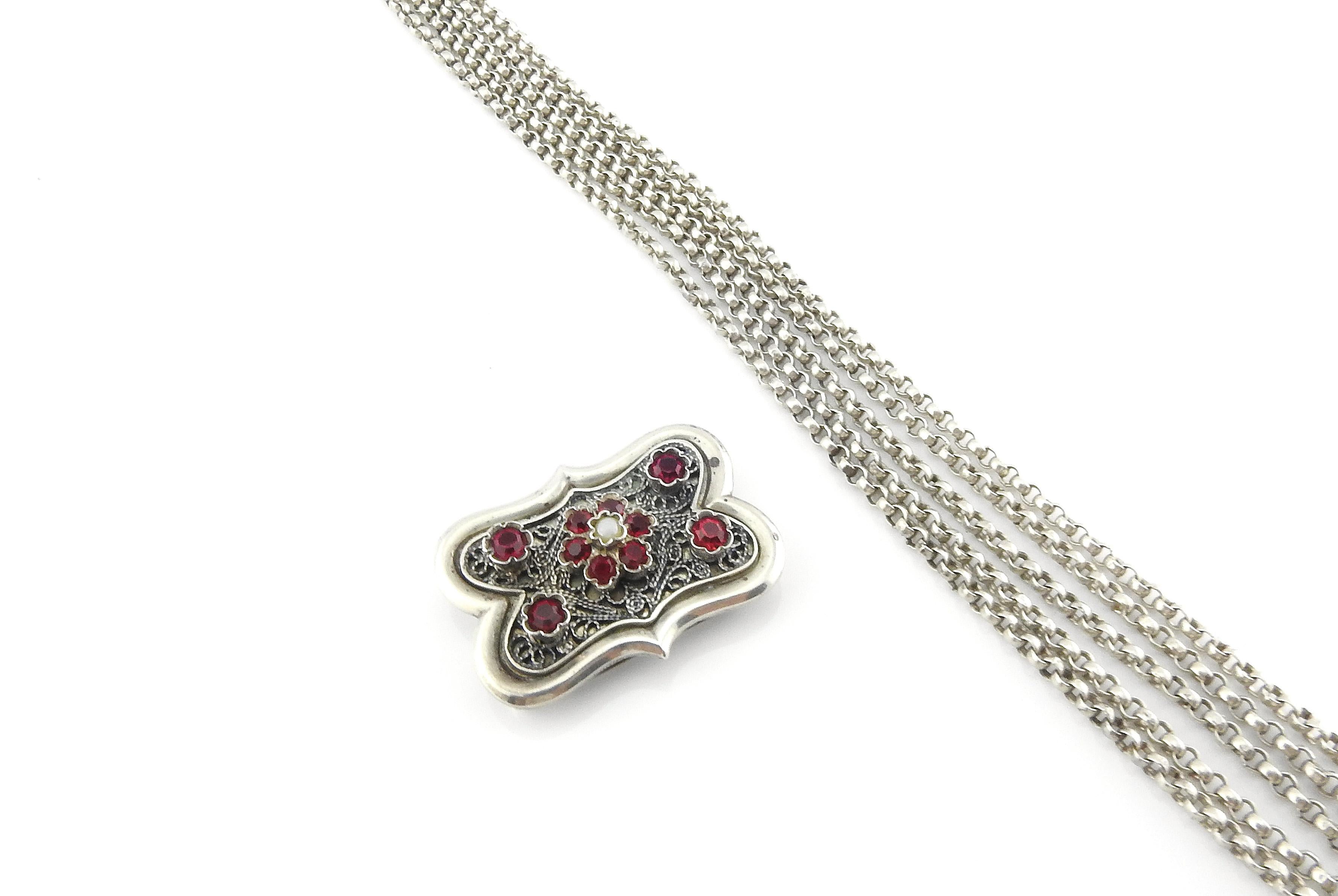 Austro Hungarian 835 silver multi strand clip off choker necklace with simulated rubies.

Victorian Era circa 1900.

Marked: 835.
Maker's or Assayer's mark of what appears to be: AGM conjoined.
Clasp and each slide is marked.

Measures: 14