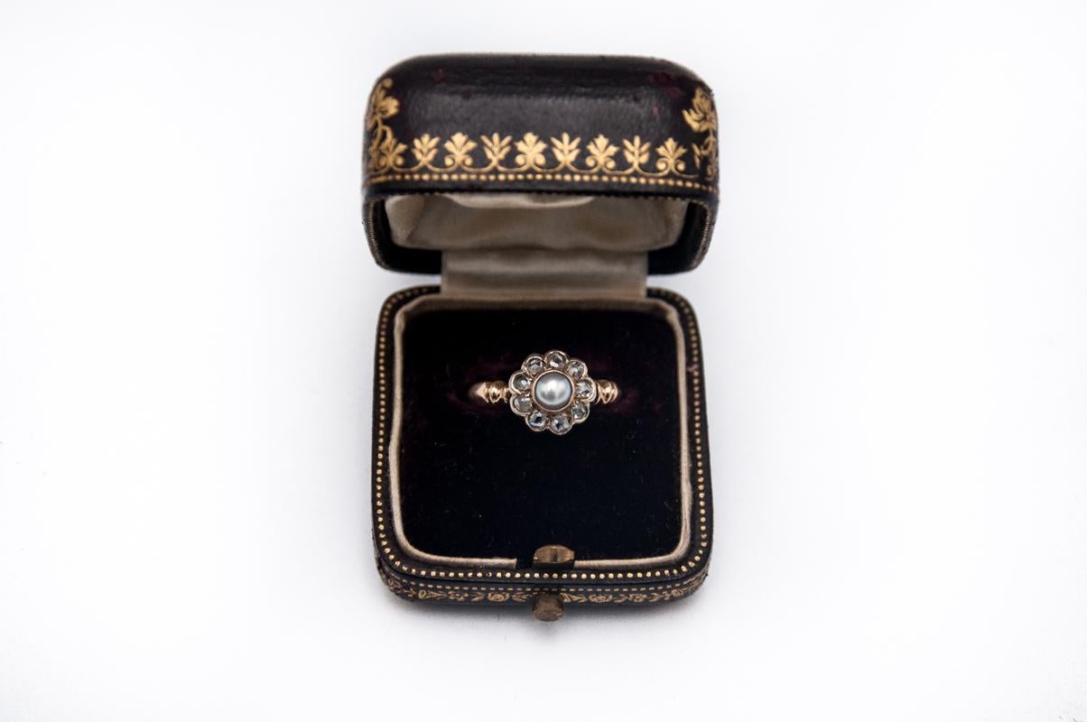An old gold ring with silver elements in the old form of carmazation - with a centrally located saltwater (cultured) pearl surrounded by nine diamonds in old cuts.

Made of 0.570 gold

Origin: Austro-Hungarian territories, early 20th century -