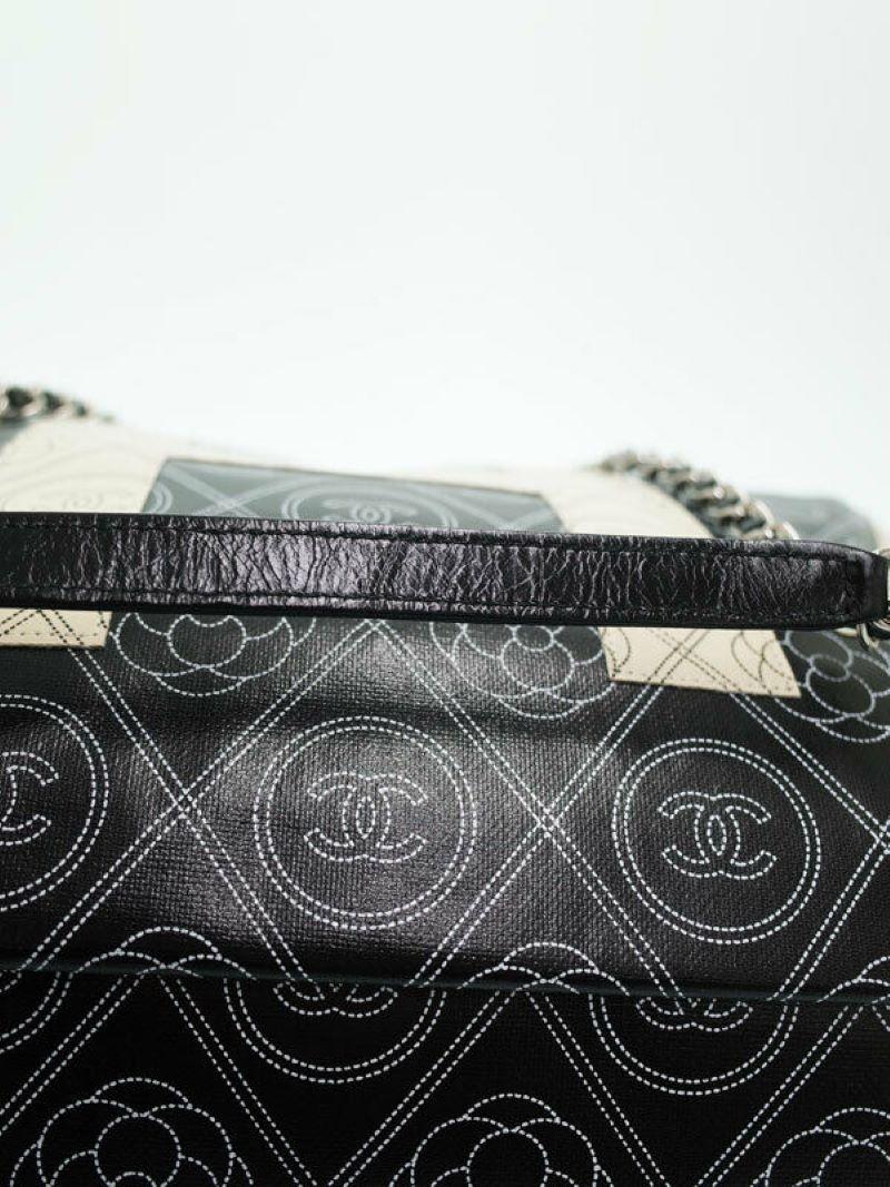 Authentic Chanel Camelia  2 way Chain Bag  
Black and white Chanel and Camelia flower design with Double CC design throughout the entire bag. The large letters spell out Chanel and flow from one side to the other side perfectly to fit within the