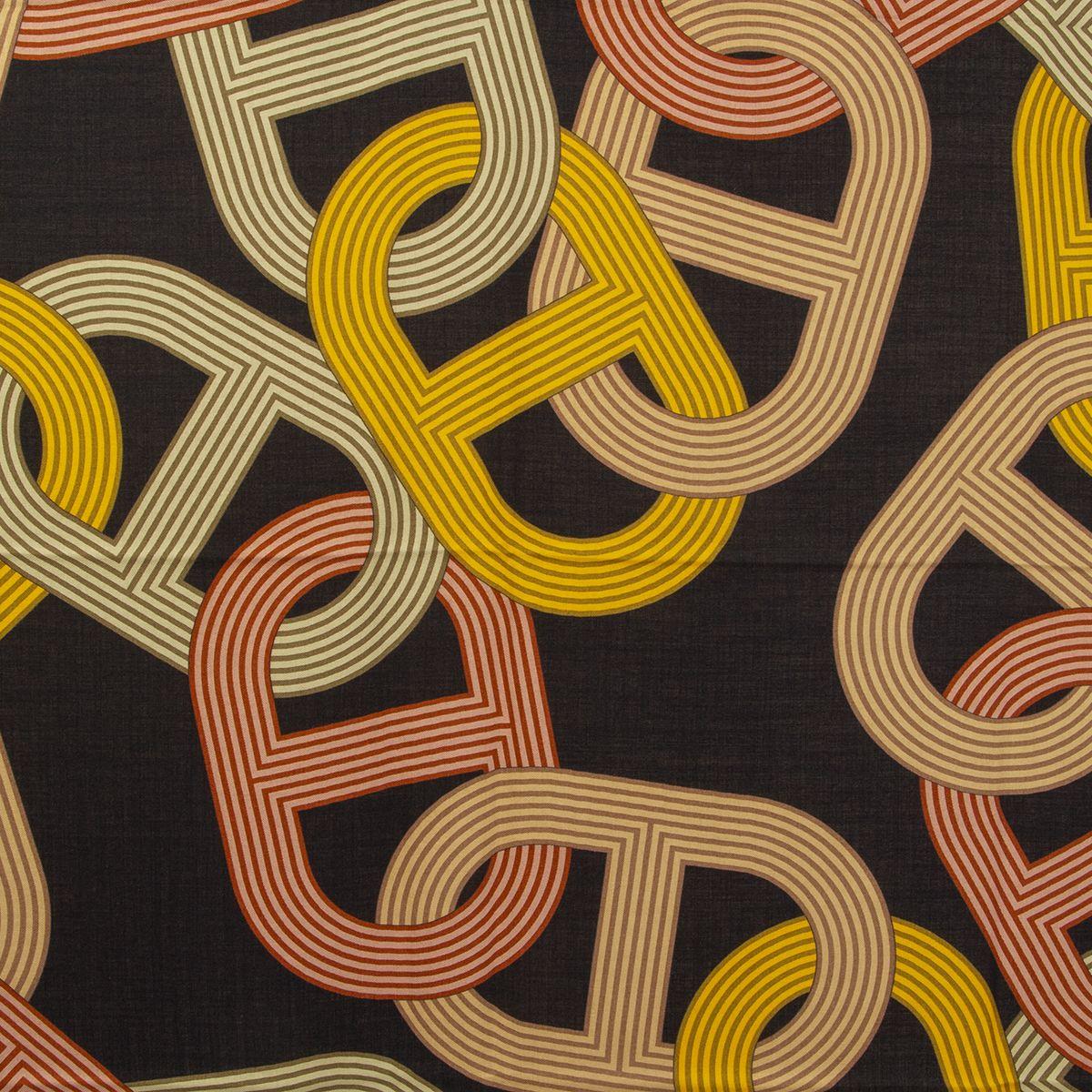 Hermes 'Circuit 24 Faubourg 140' shalw by Benoit Pierre Emery black cashmere (65%) and silk (35%) with brick and green border and details in yellow, beige and red. Has been worn and is in excellent condition.

Width 140cm (55in)
Height 140cm (55in)
