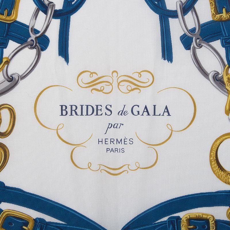 Hermes 'Brides de Gala' scarf in white silk jersey (100%) with dark blue border and details in petrol blue and antique gold. Brand new.

Width 90cm (35.1in)
Height 90cm (35.1in)