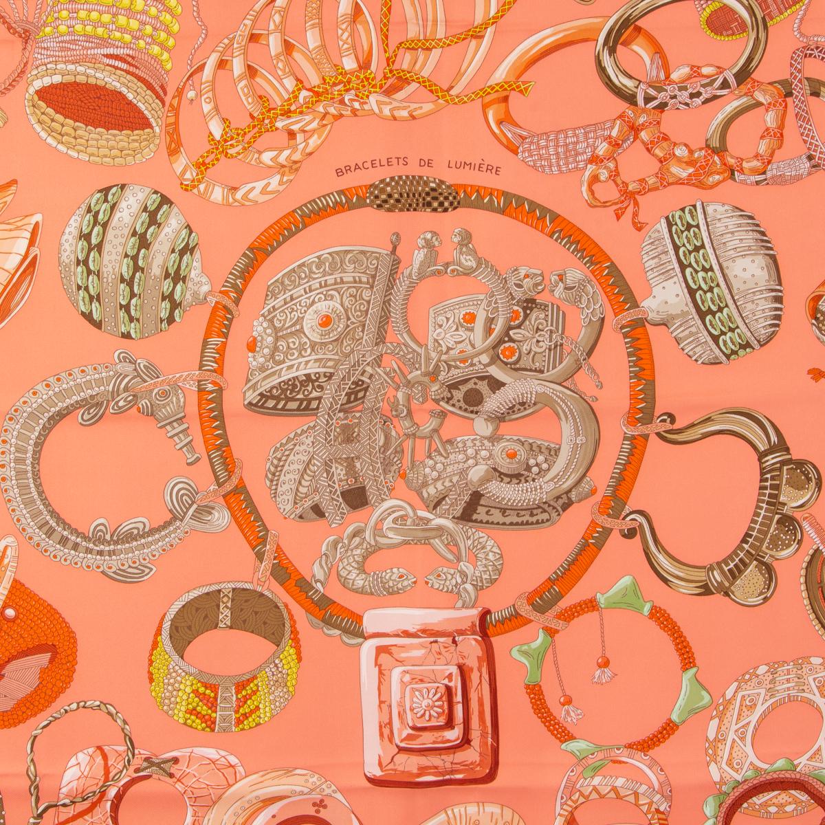 Hermes 'Bracelets de Lumiere 90' scarf by Annie Faivre in salmon pink silk twill (100%) with yellow hem and details in green and various shades of coral. Has been worn and is in excellent condition.

Width 90cm (35.1in)
Height 90cm (35.1in)
