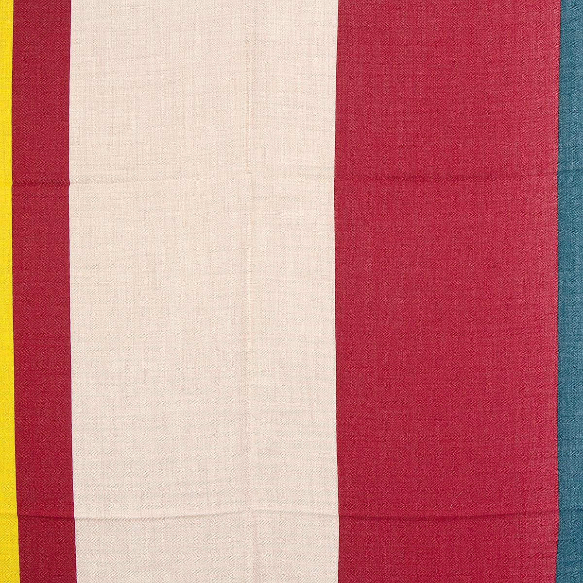 Hermes 'Encadre Club' shawl in oatmeal, dark red and teal cashmere (70%) and silk (30%) with stripes in yellow, dark red and dark grey. Brand new. No Box.

Width 140cm (54.6in)
Height 140cm (54.6in)