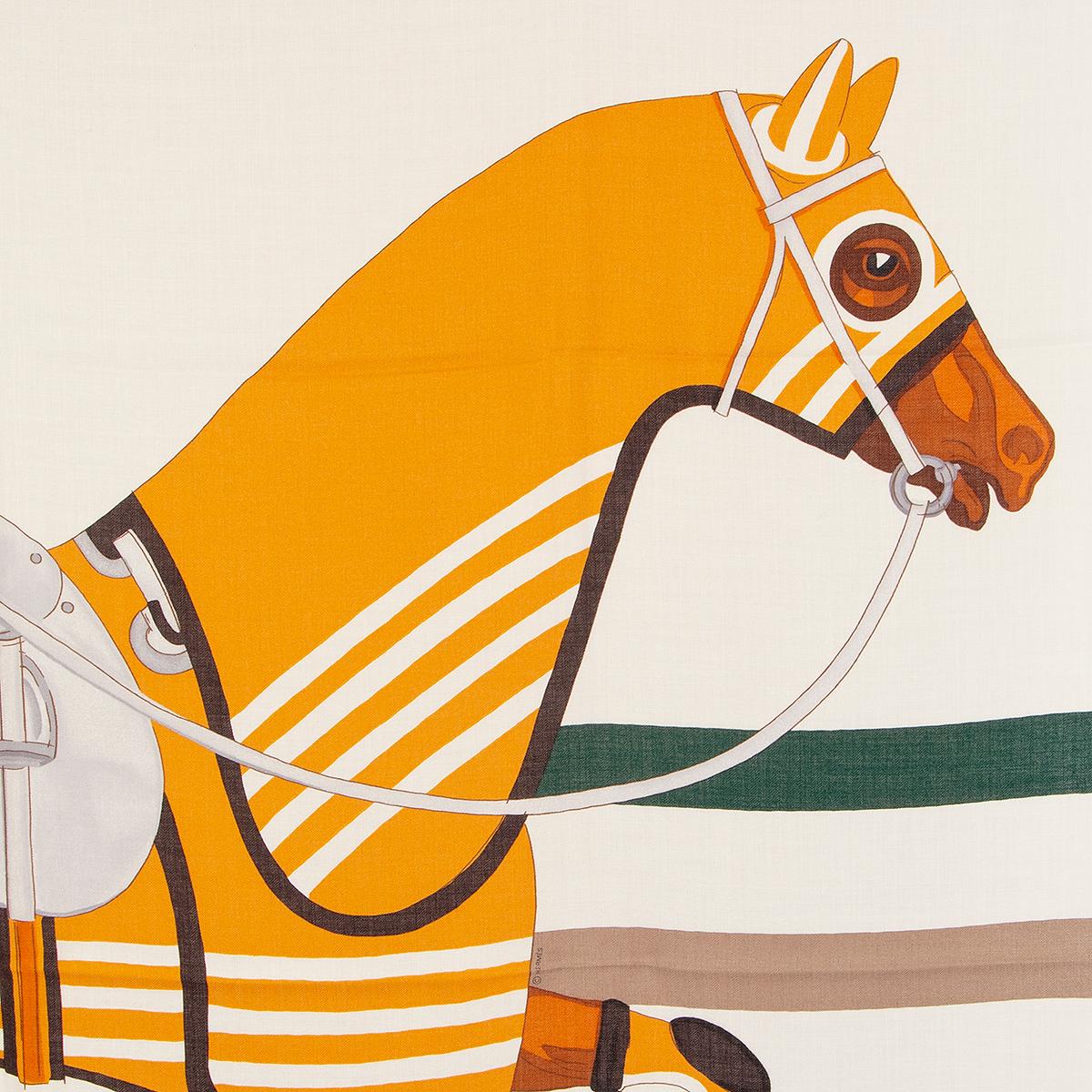 Hermès 'Cheval a la Couverture' shawl in mustard, off-white, brown, cognac,  forest green, and periwinkle cashmere (70%) and silk (30%). May have been worn and is in virtually new condition.  No Box.

Width 140cm (54.6in)
Height 140cm (54.6in)