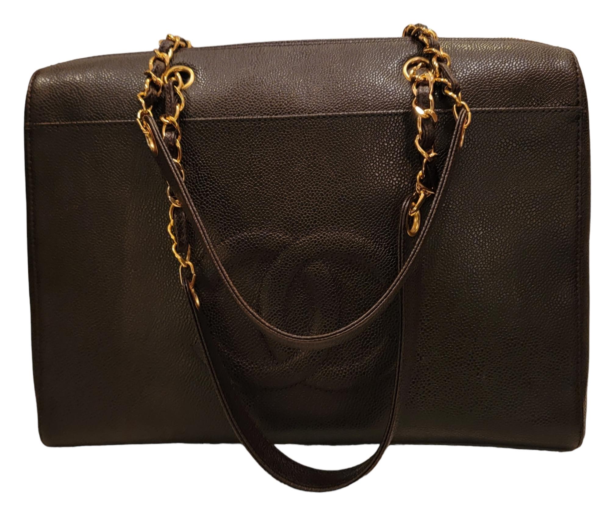 Authentic Super Jumbo Vintage Black Caviar Chanel Shoulder Bag. 
The iconic three-dimensional CC in the front of the bag is a staple of the craftsmanship of Chanels work. 
Chain and leather straps. Great caviar leather in great condition. Lightly