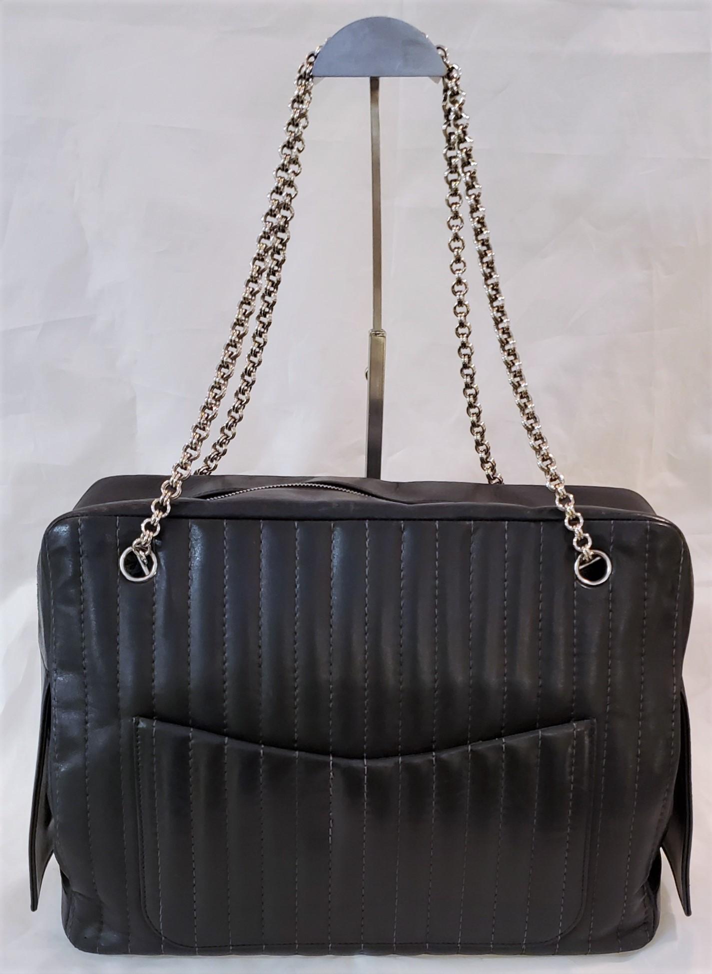 Auth Chanel Maxi Xl Leather Chained Hand Bag

Wonderful black leather look with silvered accents. The chain is a polished metal, the pull has a mall square CC accent at the tip for the scissors. The side of the bag has a lone flap that has a