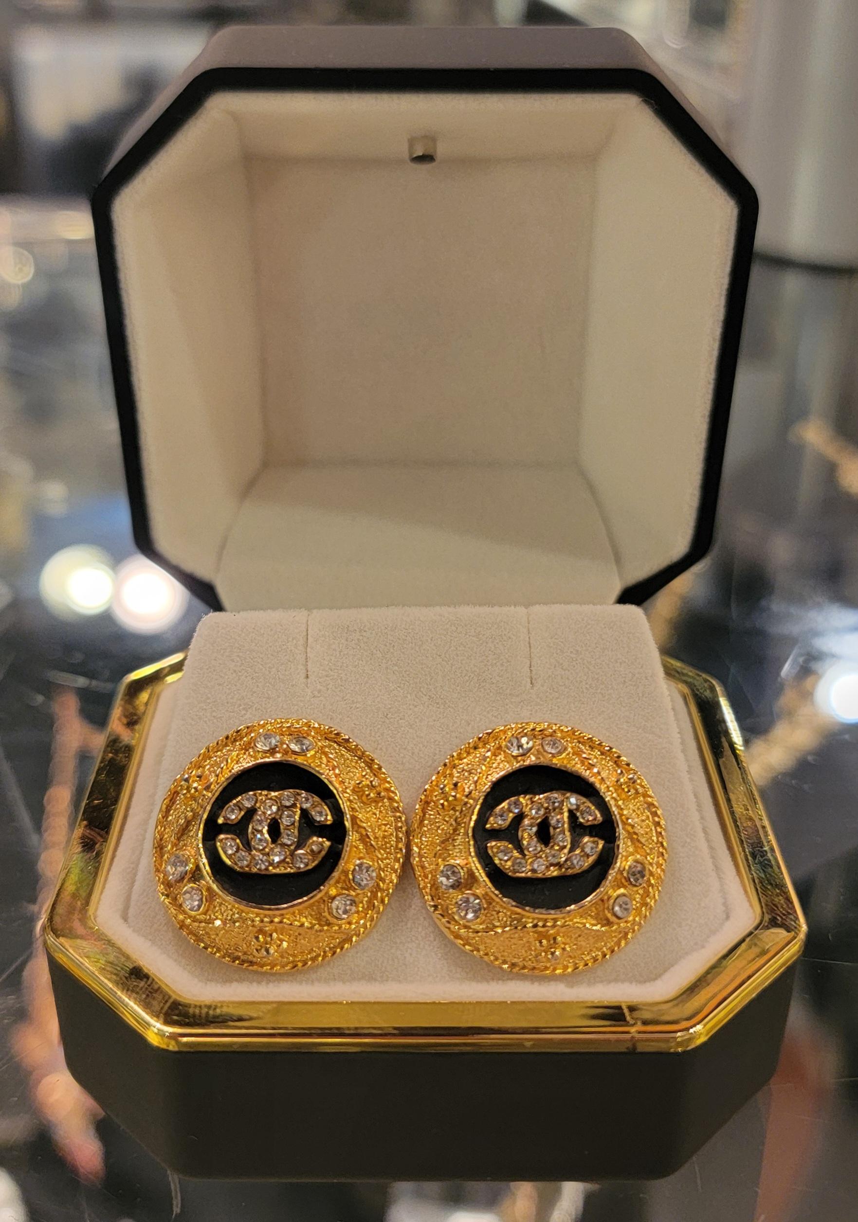 Chanel CC Stud Earrings with CC logo in the center. Beautiful Crystals throughout  the  border of the earring. There is a wonderful rope design that goes around the border of the earring around the crystals. Stamped Chanel  on the back of the 
