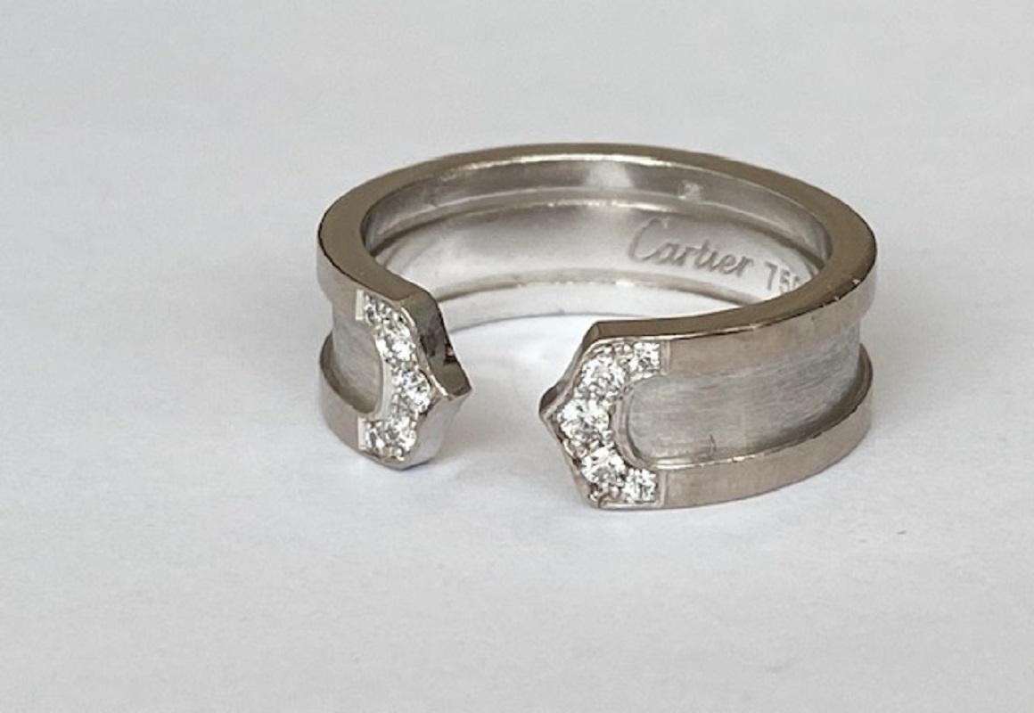 Offered in good condition: A classic C de Cartier diamond ring set in 18k white gold. The ring is handcrafted in solid 18k gold and is designed to be brushed gold in the centre with polished outer sides. The band flows round nicely to the front of