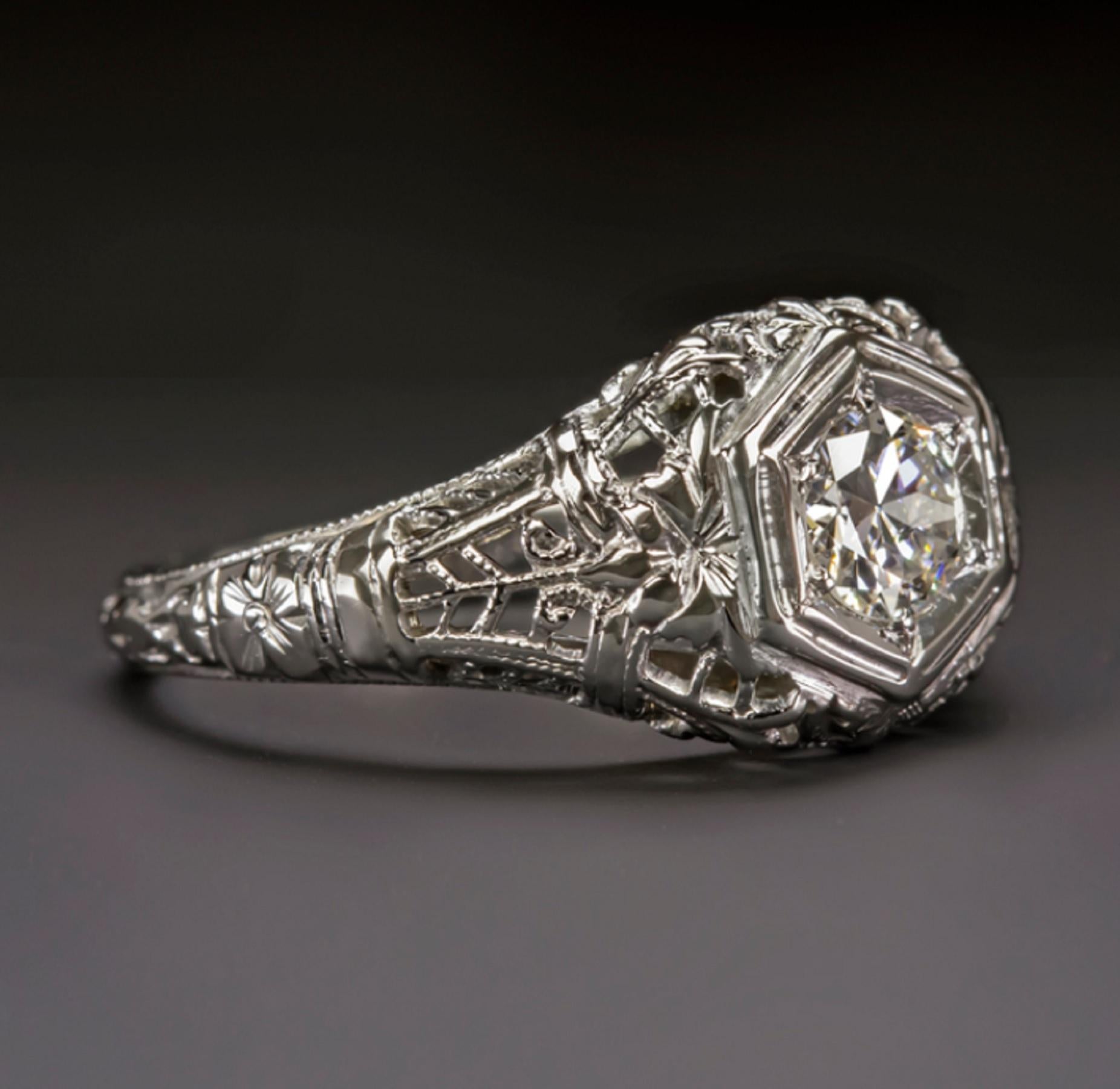 An original vintage ring showcases a lively old European cut diamond accented with intricate filigree and richly textured hand engraving. 

The workmanship on the ring is amazing and a perfect compliment to the high quality center diamond. The hand