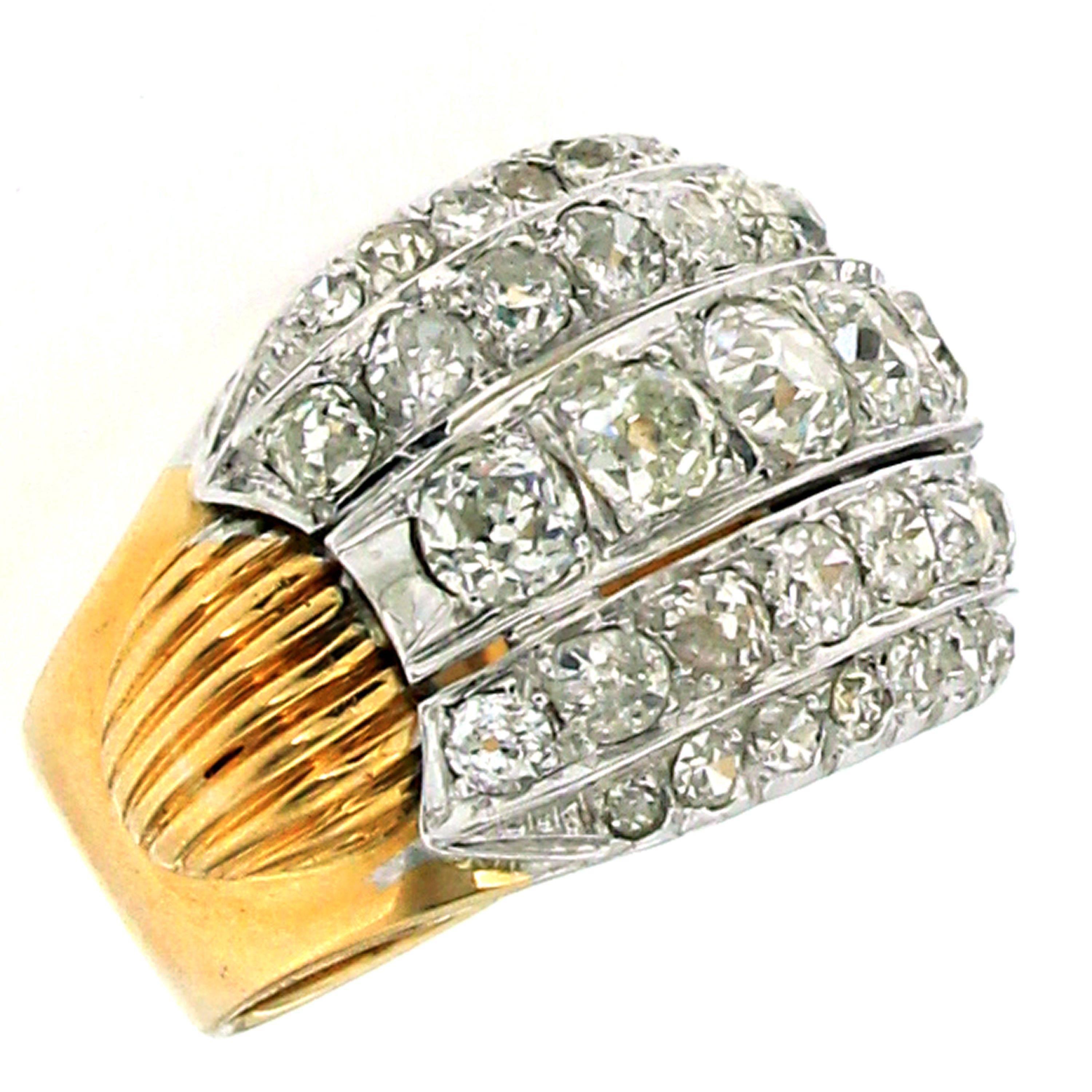 An Authentic Retro ring, original from 1940, made in Italy, mounted in 18k yellow and white gold.

The ring has a wide, textured band comprised of ridged grooves that travel around the entire outer surface, in the center there are five horizontal