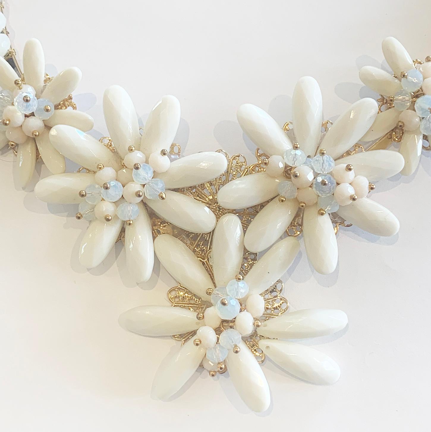 Mid Century Gilt and signed, “Escada” Necklace. Escada was founded in 1978 by Margaretha and Wolfgang Ley in Munich, Germany. An adjustable Collar, with Blue and white Opalescent centres to Daisy Pendant, with multi-facetted Milk Glass petals that