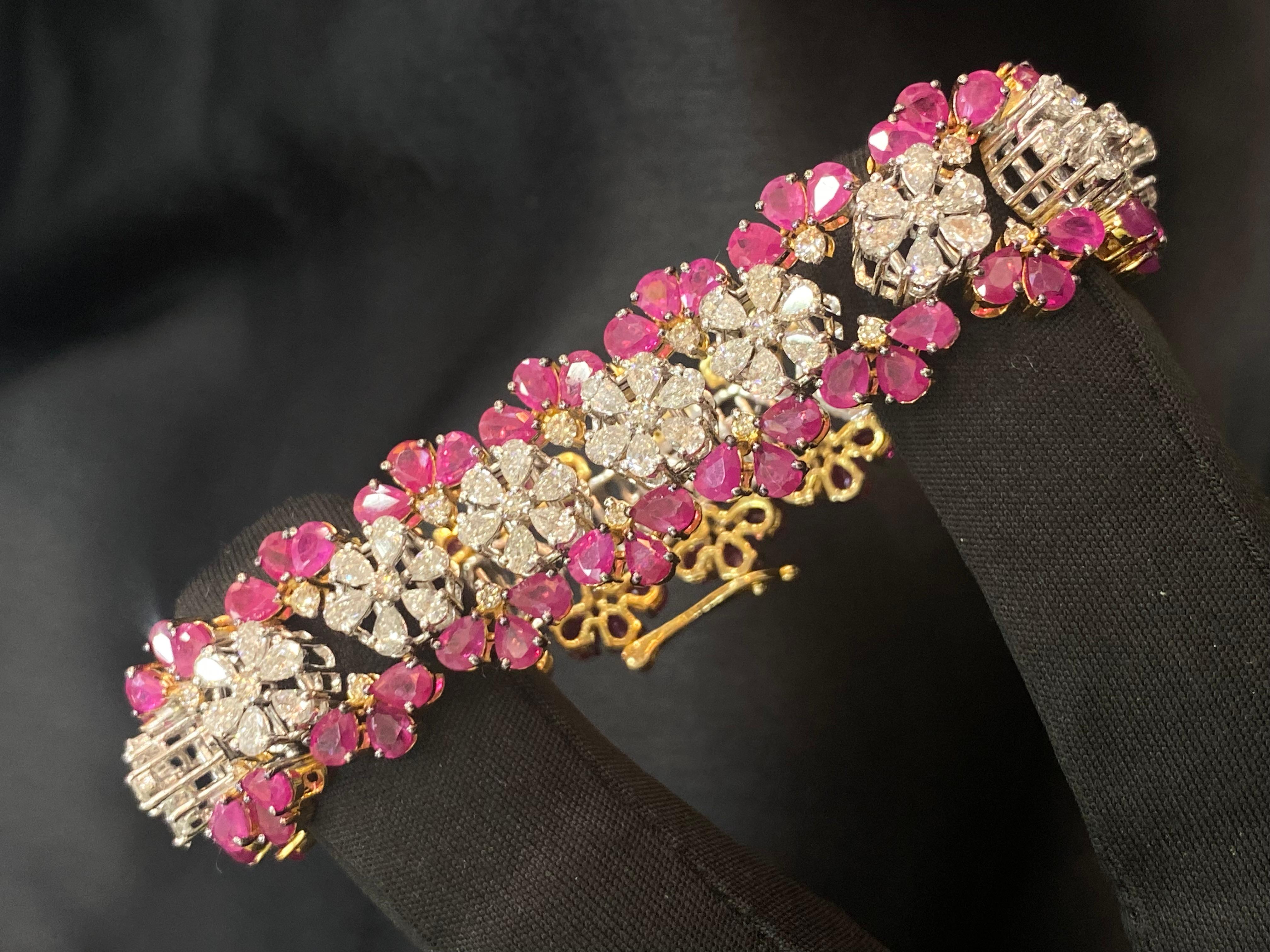 Behold this exquisite tennis bracelet, adorned with 7.42 carats of pear and round brilliant cut diamonds, accompanied by 23.65 carats of natural pear-shaped rubies, all delicately set in fine 14K gold. Perfect for any occasion, this stunning piece