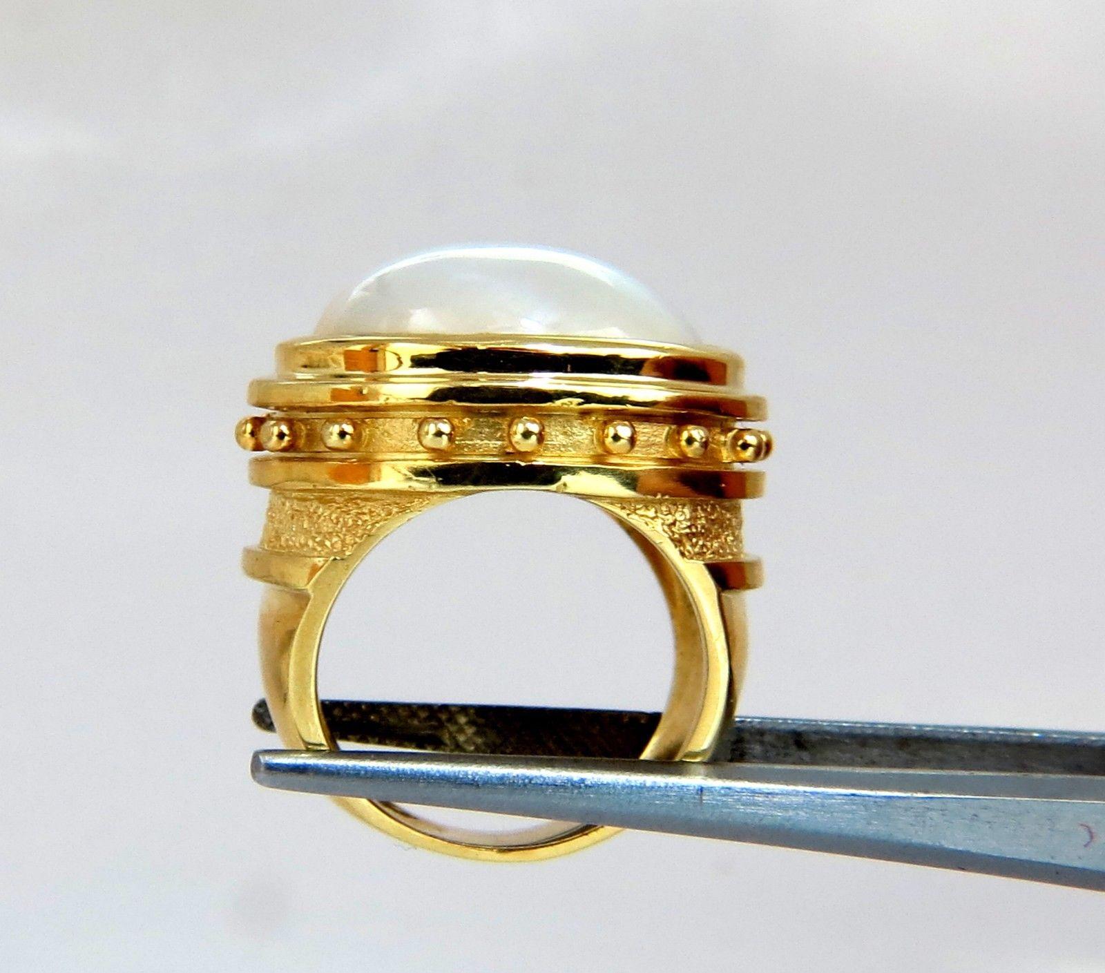 Designer: Aletto Bros.

16 x 12mm Mabe Pearl Ring

Stud Bead Girdle, Encircling Profile

Excellent detail.

14kt. yellow gold

15.7 grams.

Current ring size: 4.75

We may resize.

Depth of ring: 10.3mm

Deck of ring: 17 x 19mm