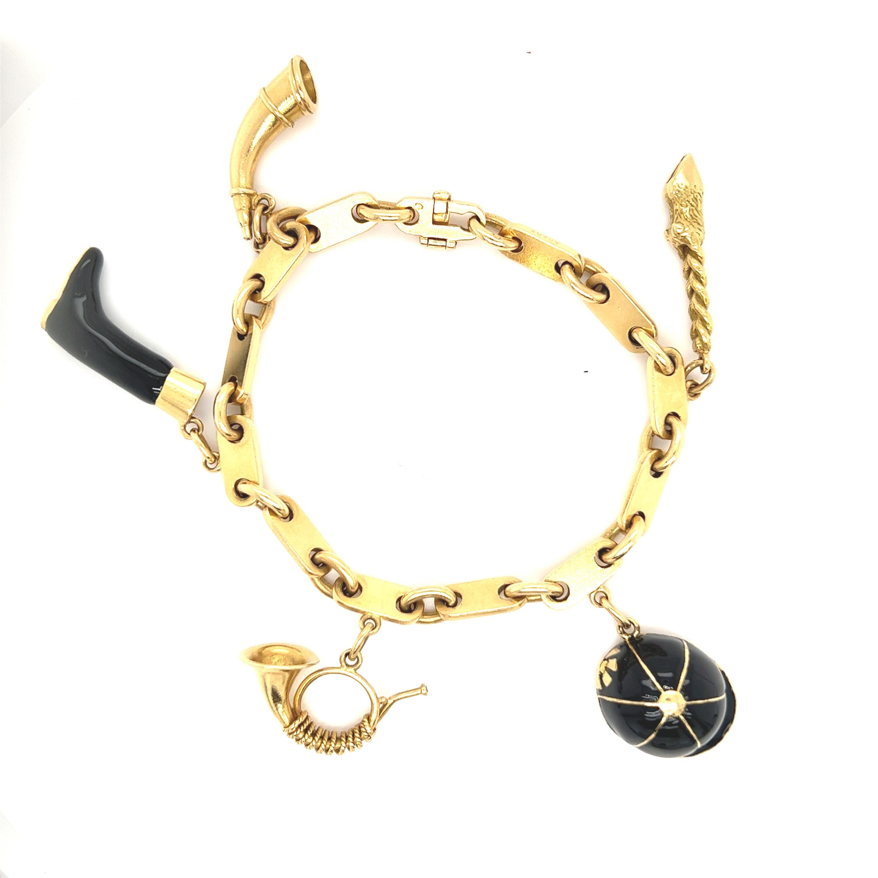 Very Rare Hermes Charm bracelet: 

18ct Yellow Gold Enamel Equestrian Charm Link Bracelet by Hermes.  

Includes a total of 5 Hermes charms:  

Hat: 20mm x 16mm boot 24mm x 14mm 
Horn: 26mm x 8mm 
Horn: 24mm x 15mm 
Lucky Rabbit foot: 31mm x 6mm 