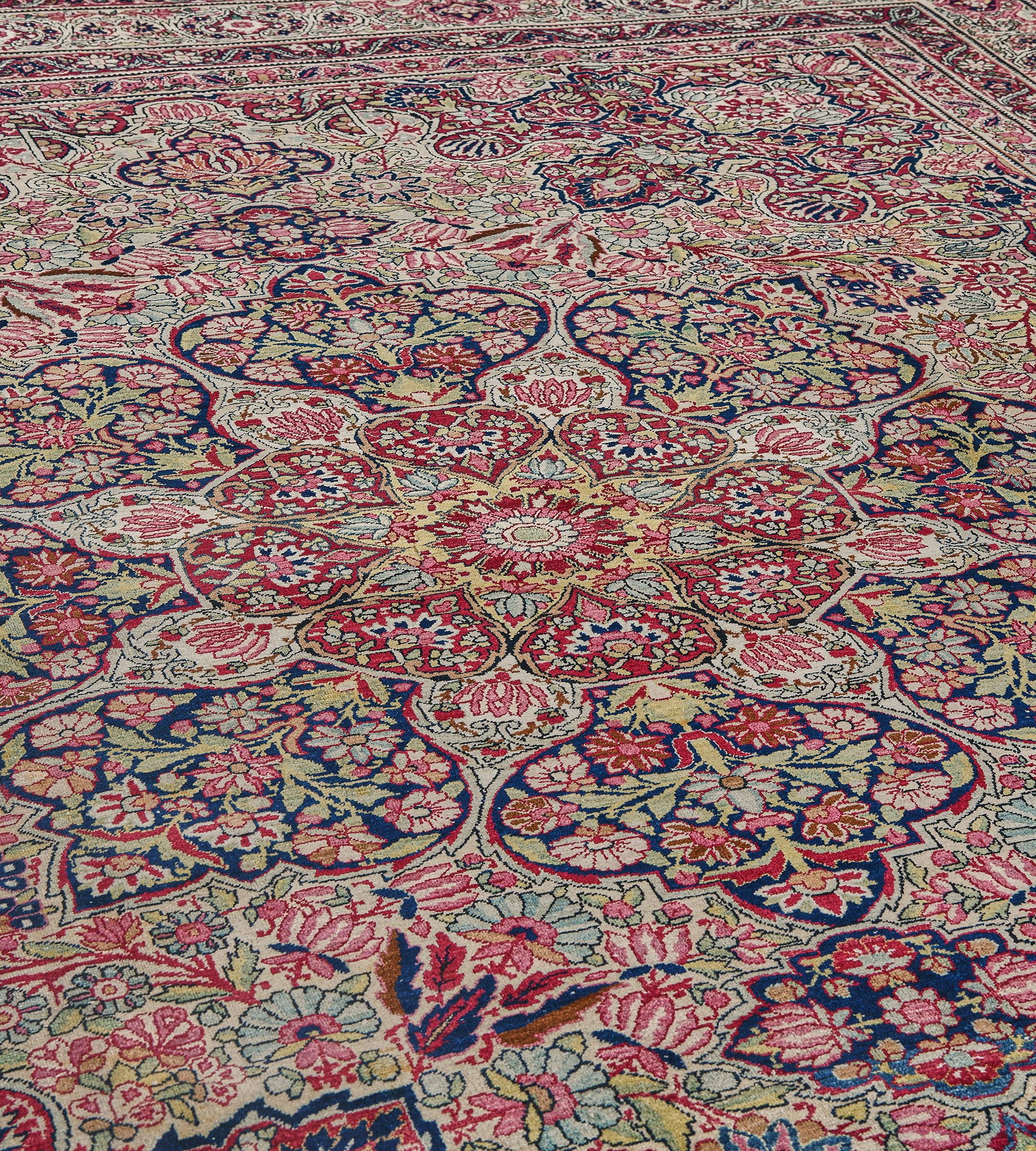 This traditional handwoven Persian Kerman rug has a vibrant ivory field of dense scrolling floral motif enclosing a detailed imperial medallion, enclosed by similar regal spandrels, in an ivory dense linked turtle palmette border, between elegant