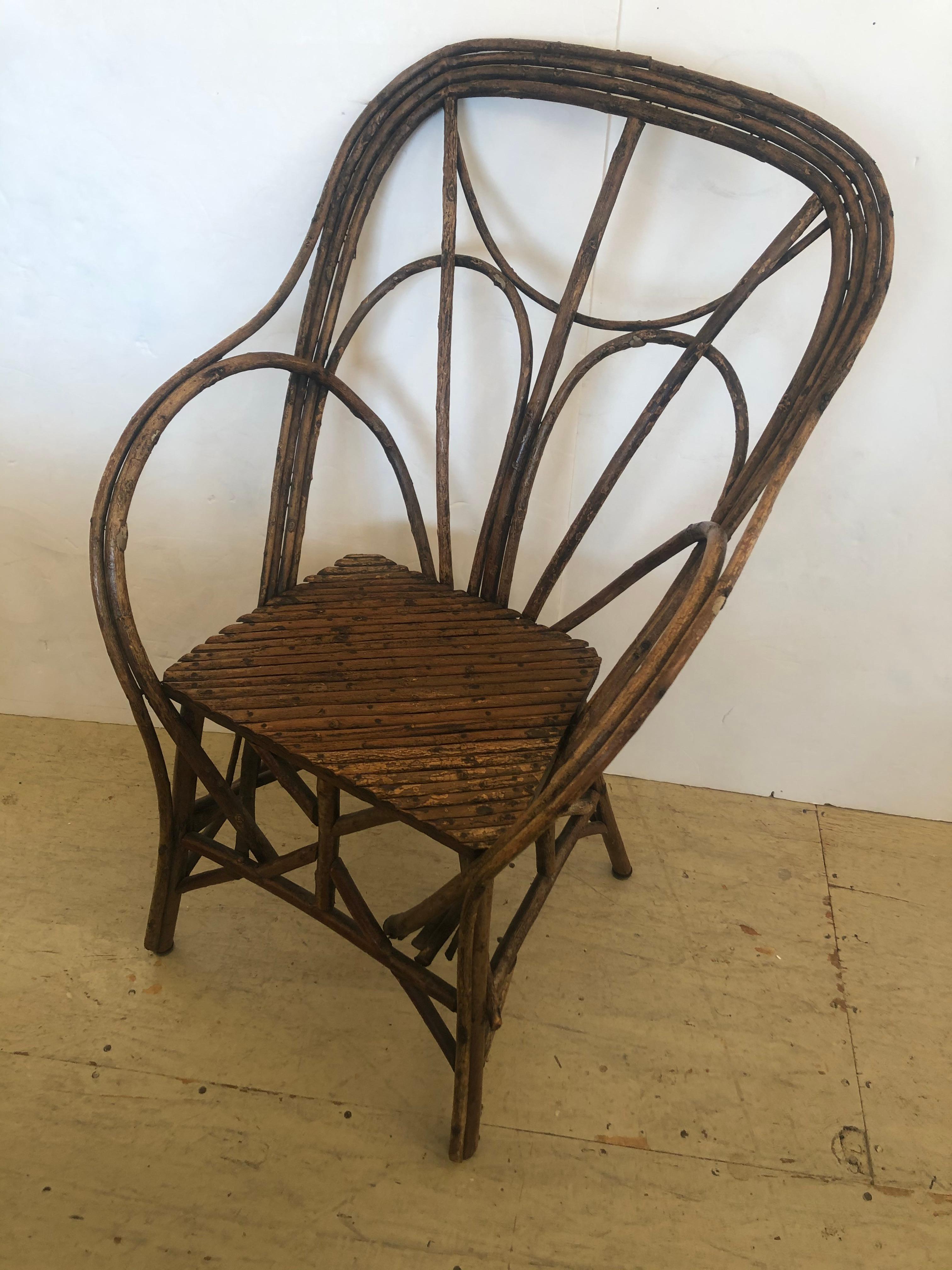 Authentic Adirondack rustic twig arm chair having beautiful workmanship and antique character. Sturdy and comfortable. Measures: Arm height 26 seat depth 11.5.