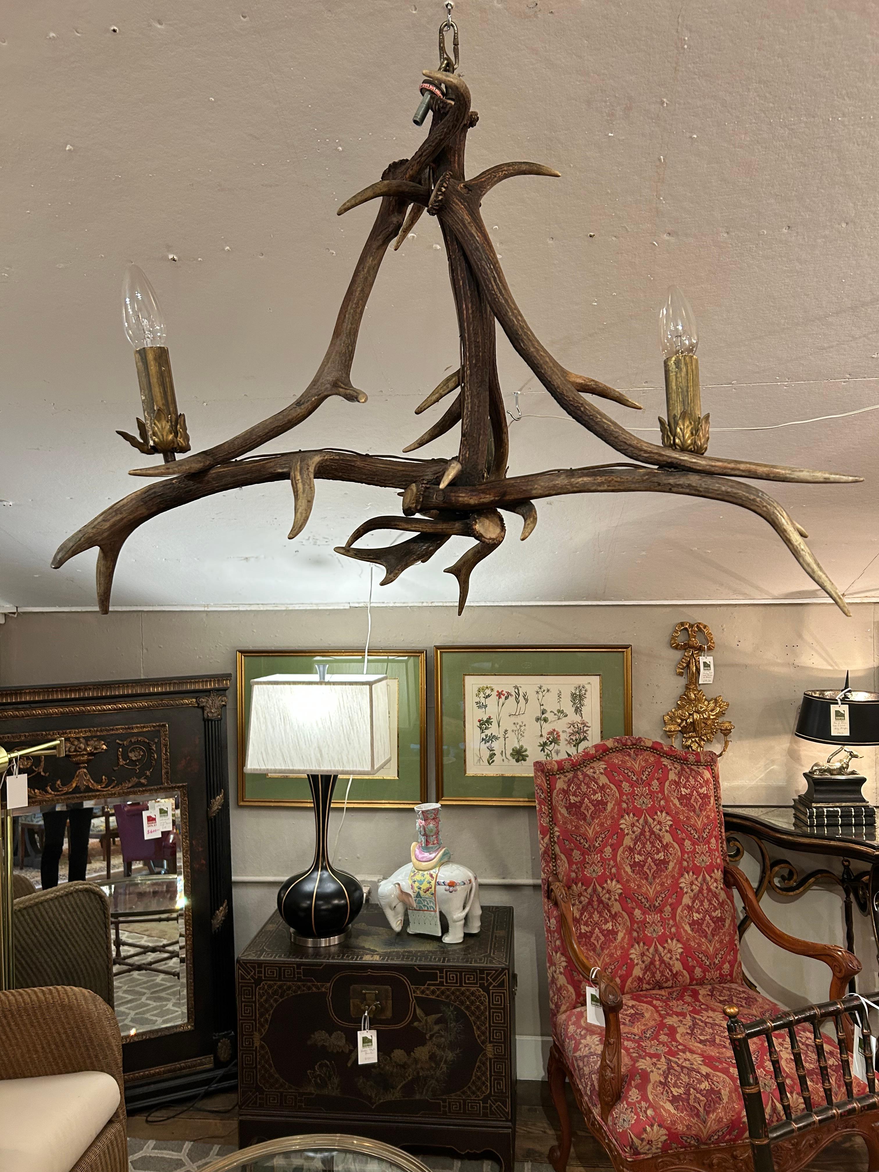 3 lights, 60 watt each
Authentic antler chandelier having 3 arms and unusual  great shape.