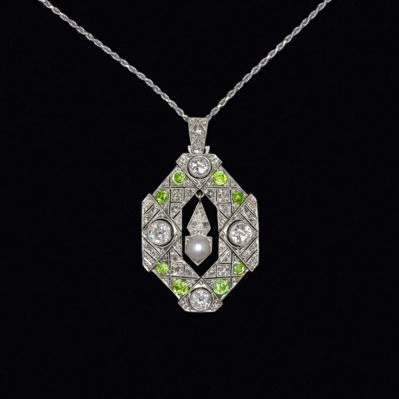 Authentic Art Deco Diamond, Pearl & Demantoid Garnet Pendant Necklace in 14K White Gold (Circa 1920s)
A true Art Deco masterpiece, this exquisite pendant necklace from the 1920s features a captivating combination of diamonds, demantoid garnets, and