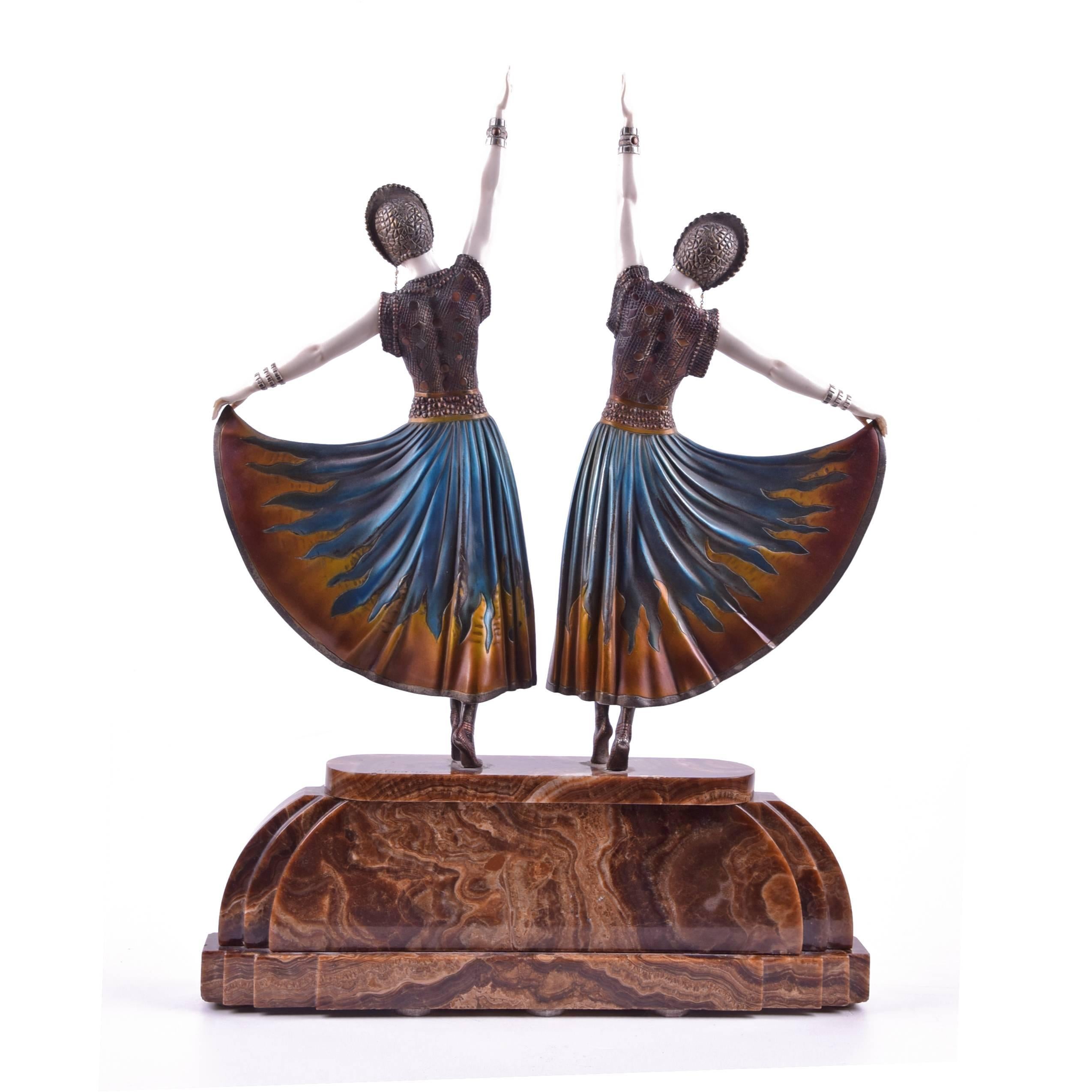 'The Dolly Sisters' an Important Art Deco cold-painted bronze sculpture group, circa 1925
cast and carved as the legendary performing twin sisters in stage costume, wearing flamboyant pleated dresses with a flame design to the skirt and elaborate