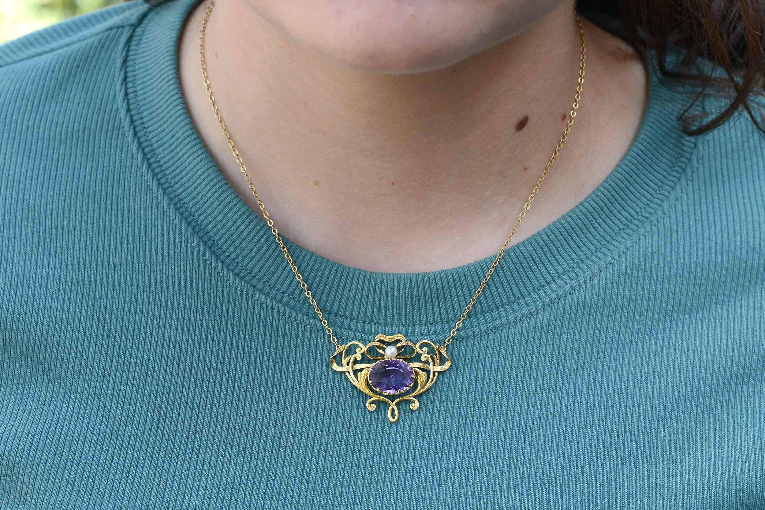 With sinuous, scrolling, flowing vines, this authentic antique Art Nouveau amethyst necklace is a dynamic and naturalistic accessory. A masterpiece circa 1910, hand fabricated of buttery 14k yellow gold with raised fretwork vines terminating with a