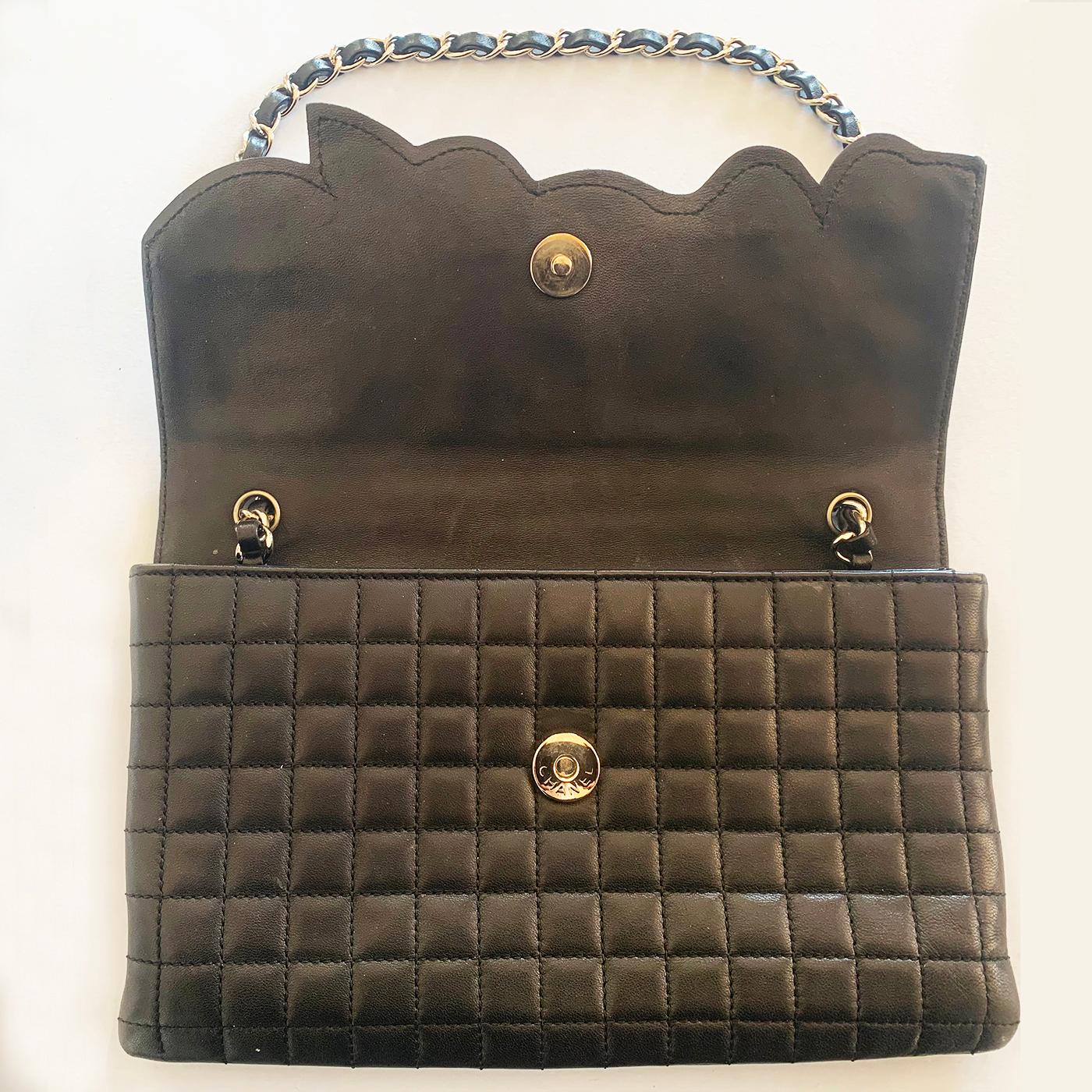 Authentic Chanel Black Camelia Clutch or Handbag, double interior, Zipped pocket to one, and in original Box. The Shoulder leather plaited shoulder chain can be folded to the inside, for it to be used as a Clutch if desired. The Authentication