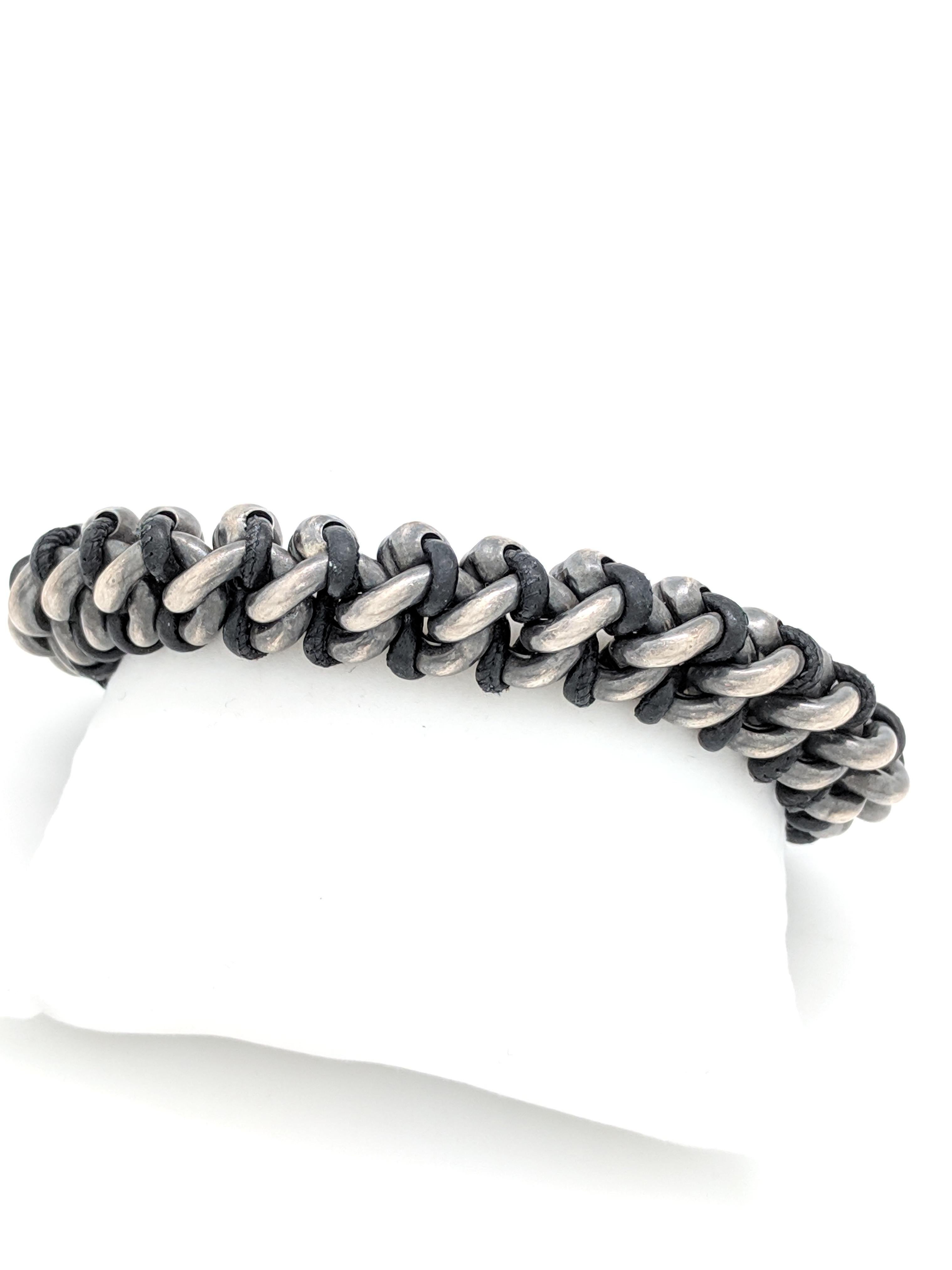 Authentic Bottega Veneta Men's Black Oxidized-Silver and Woven Leather Bracelet

You are viewing an Authentic Bottega Veneta Men's Black Oxidized-Silver and Woven Leather Bracelet. This bracelet is crafted from sterling silver and black leather. It