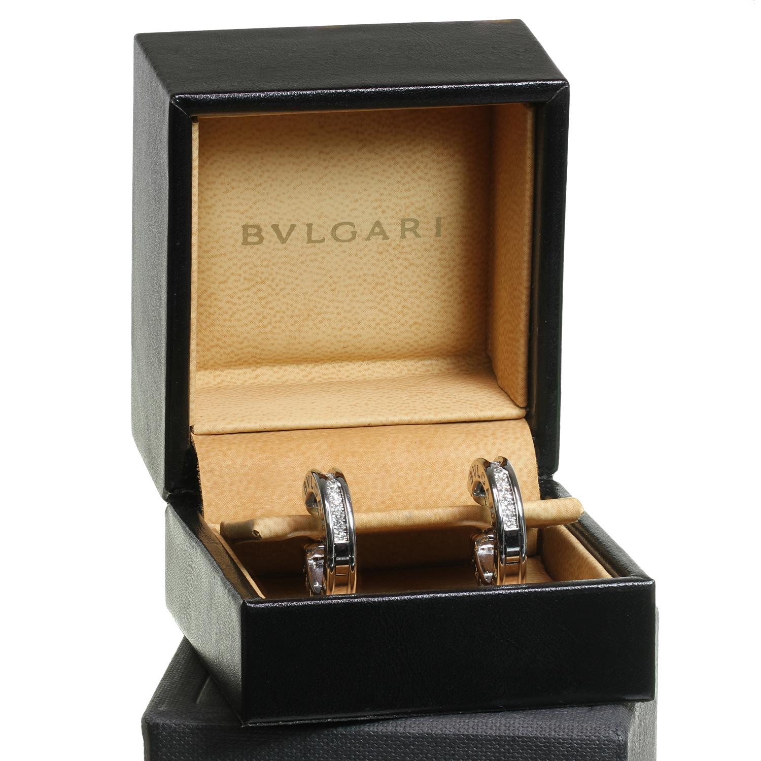 This gorgeous earrings from Bulgari's iconic B.zero1 collection feature a a hoop design crafted in 18k white gold, engraved with the Bvlgari logo on both sides and pave-set with brilliant-cut round E-F-G VVS2-VS1 diamonds weighing an estimated 0.60