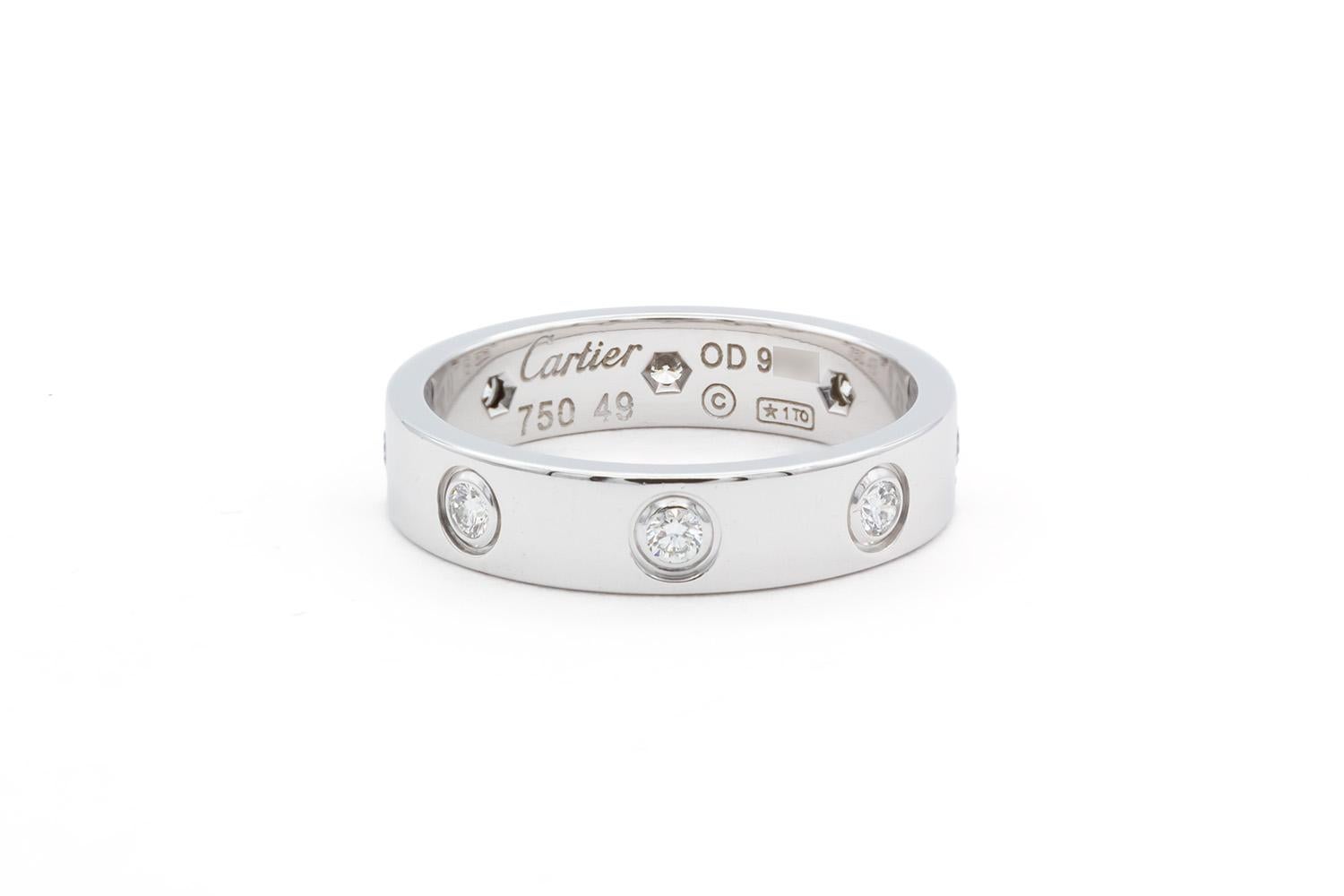 We are pleased to offer this Authentic Cartier 18K White Gold 8 Diamond Love Ring, just back from Cartier for a polish. This classic Cartier ring features their love design set with 8 diamonds in 18k white gold. It is a size 49 EU/4.75 US and