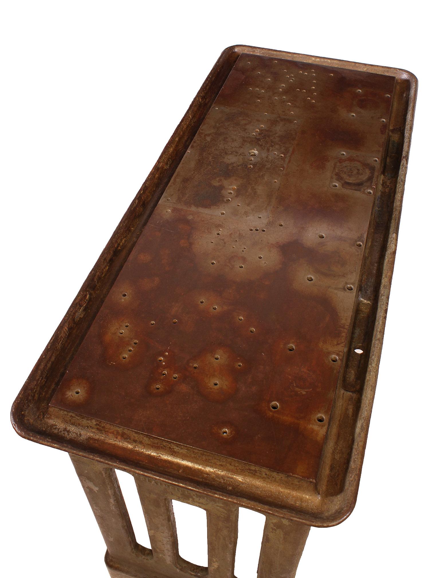 Original vintage Industrial cast iron work machine table. Beautifully worn top that features a 'moat' used for collecting machine oil. Art Deco in style, would make a great statement piece as a desk or display table. Overall dimensions measure: 49