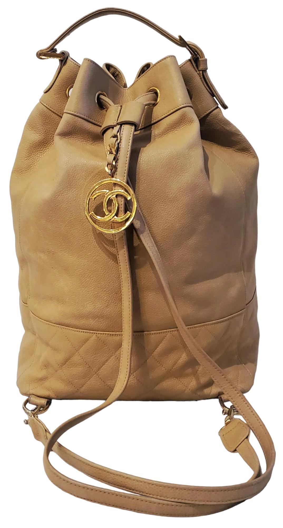 Authentic Chanel Camel Caviar Skin Backpack Gold.
Tan Caviar leather drawstring backpack/ handbag. The straps are adjustable and removable. There is a gold CC pendant on the long backpack straps that adjust with tightening of the straps. The handbag