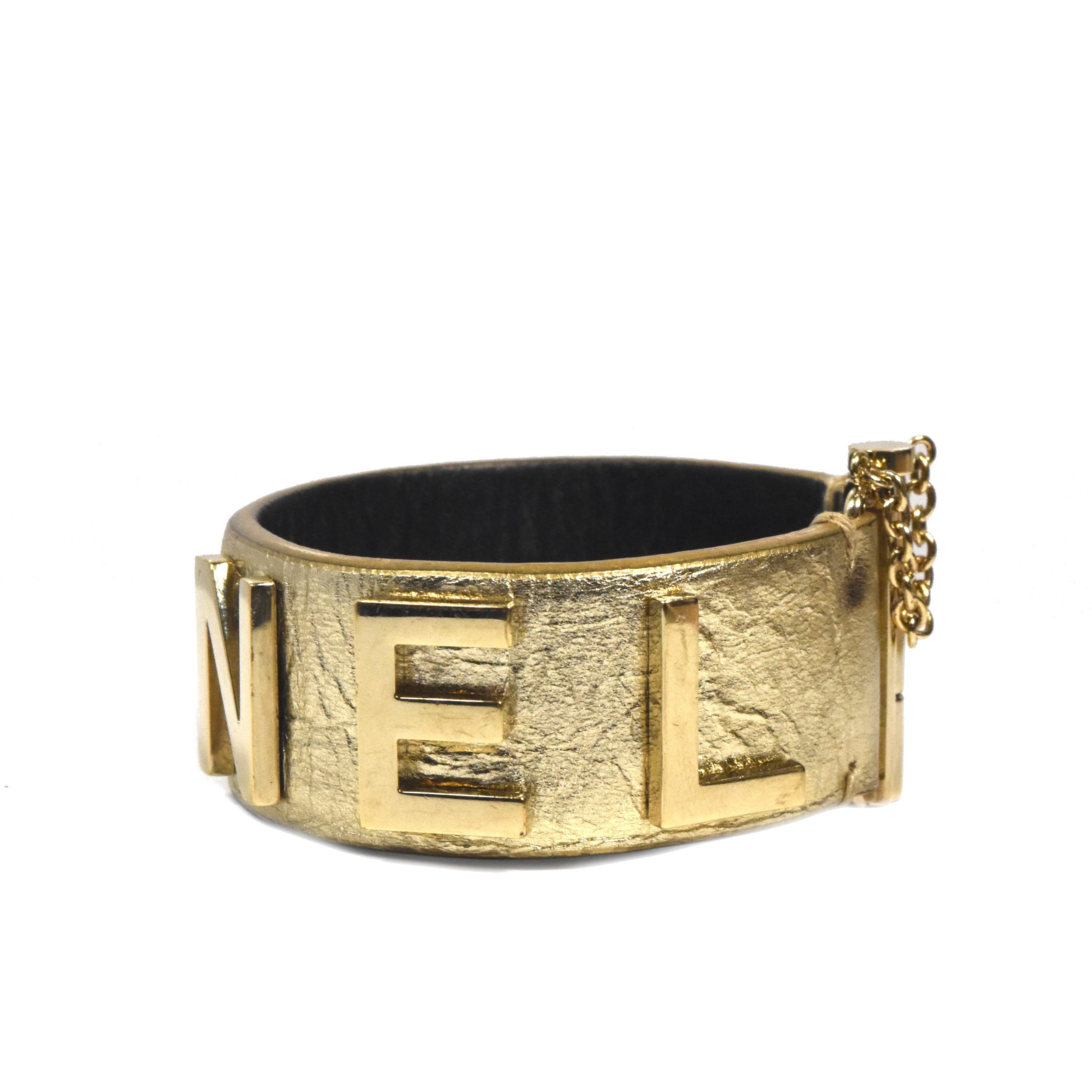 Bold look for this gold calfskin leather bracelet accented by large gold hardware Chanel logo and a slide lock closure. Timeless piece in good condition.

Designer: CHANEL
Style: Logo Cuff
Material: Calfskin Leather 
Clasp: Slide lock
Year: Approx.