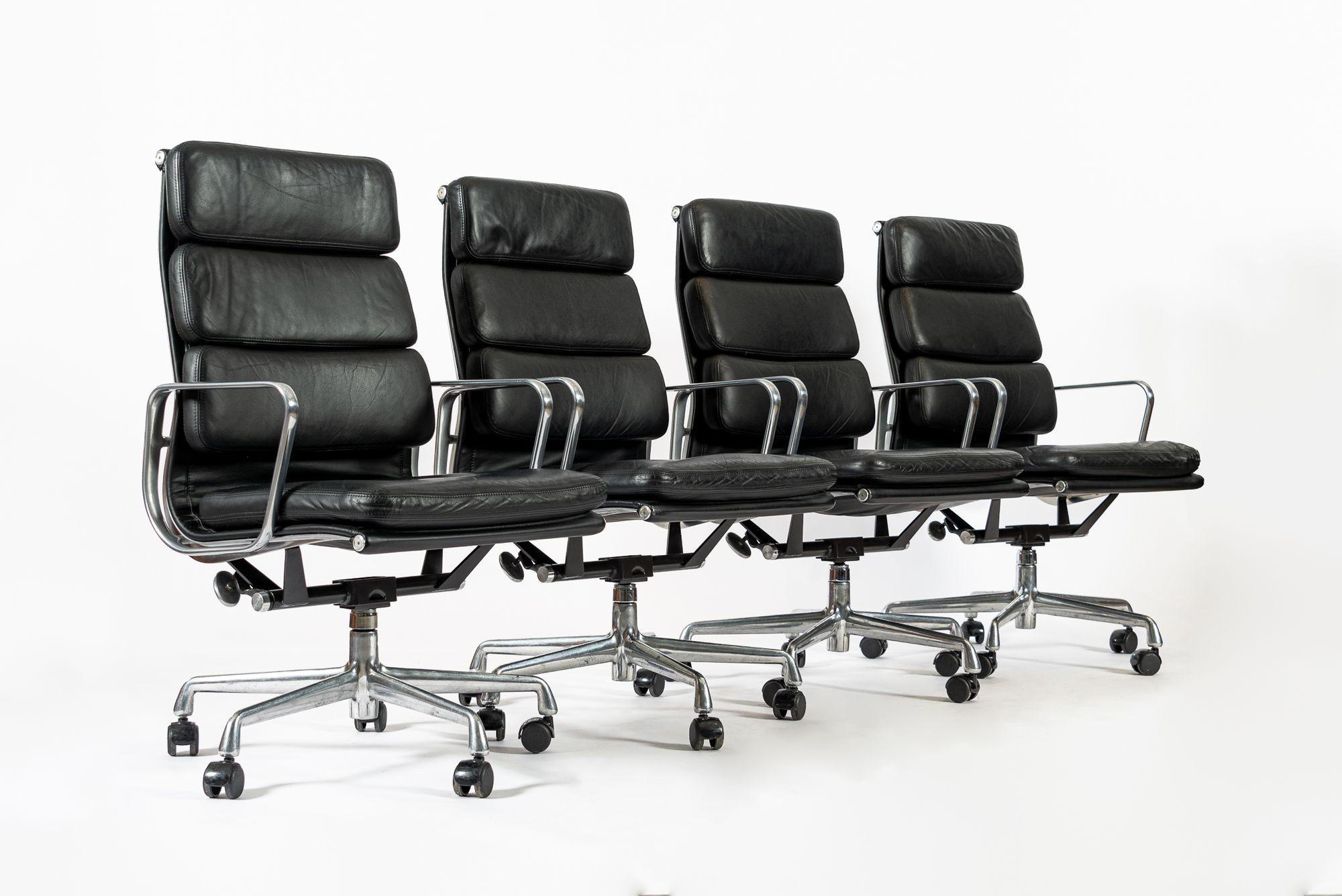 These authentic Eames for Herman Miller Soft Pad Executive Height office chairs from the Aluminum Group Collection were manufactured in 2001. These executive height chairs feature a taller backrest, original black leather upholstery, polished