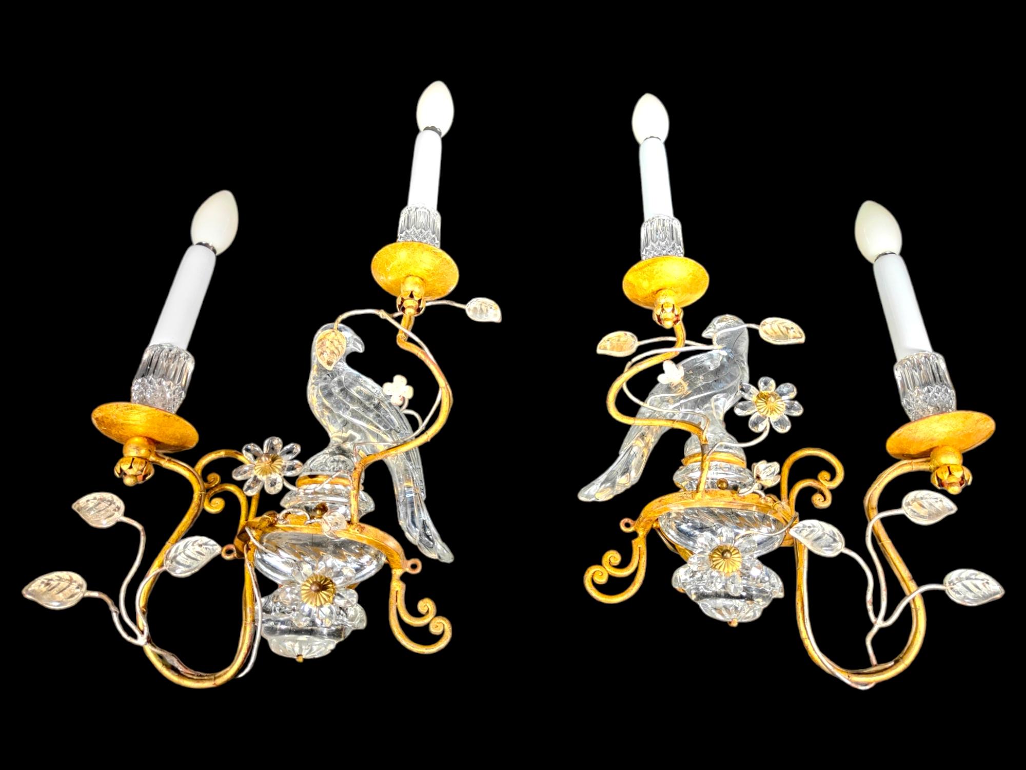 Authentic French Art Deco Maison rings crystal opposite face parrot appliques
Authentic French Art Deco Maison Bagues cristal opposite face parrot sconces A pair of authentic French Art Deco style crystal and leaf wall sconces circa 1950. The