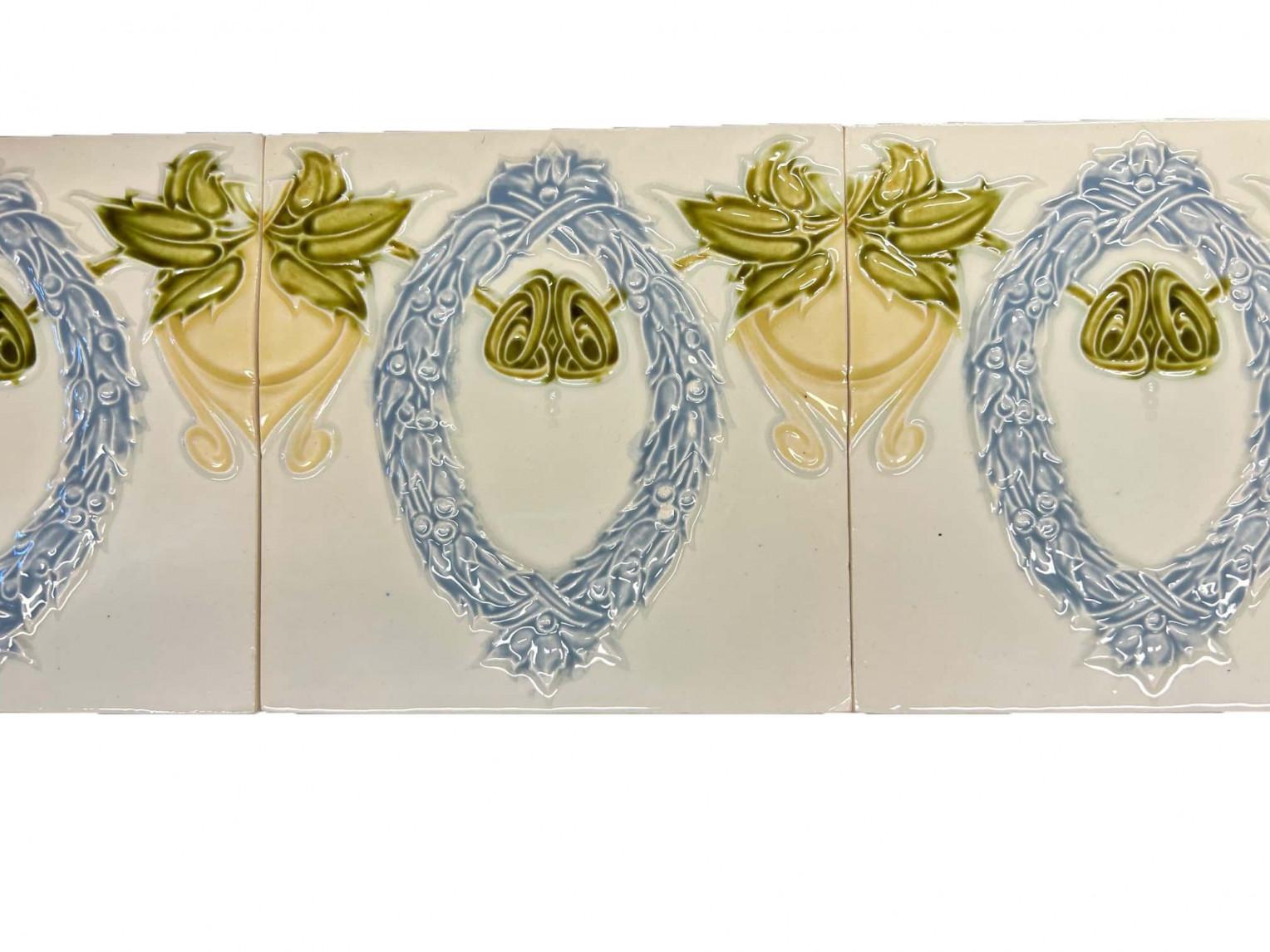 Si tratta di un fantastico set di antiche piastrelle Art Nouveau fatte a mano con l'immagine di una corona d'alloro in rilievo nei colori blu, verde e giallo. Queste piastrelle sarebbero incantevoli se esposte su cavalletti, incorniciate o