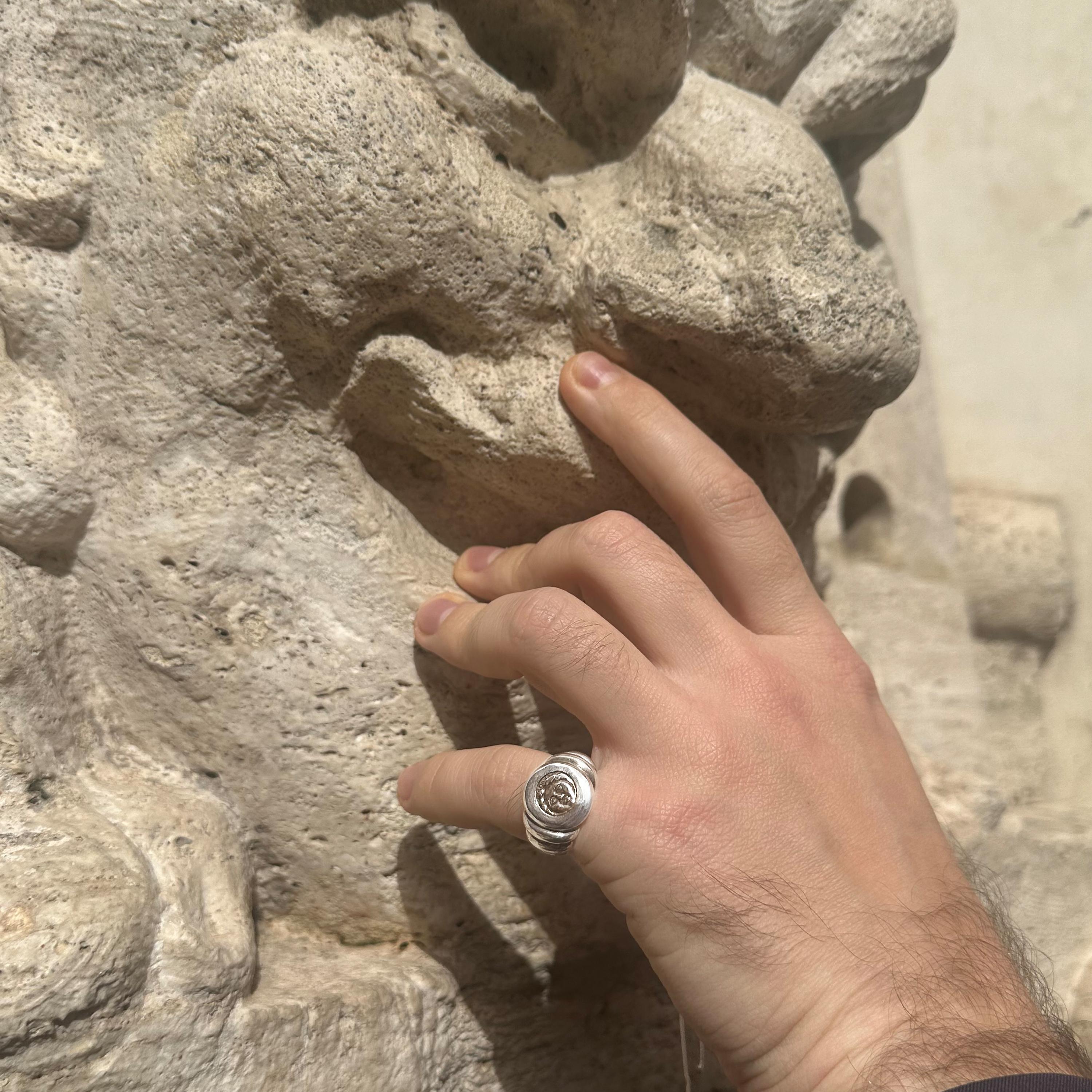 This sterling silver ring features an exquisite relic—a genuine silver coin hailing from Apollonia Pontica in Thrace, estimated to originate between 450 and 400 BC. Imprinted upon this historic coin is a striking depiction of the revered deity