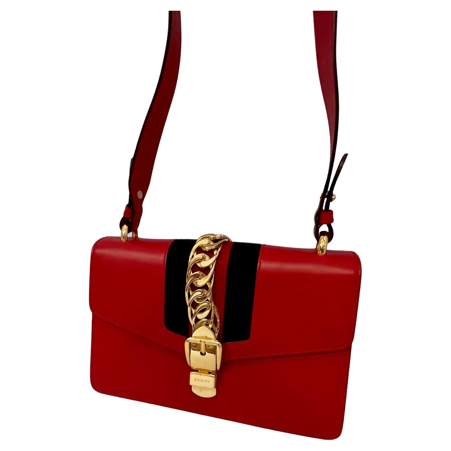 Special Occasion · Genuine Leather · Nylon · Reds
This is an authentic GUCCI Calfskin Maxi Sylvie in Red. This structured clutch is crafted of smooth red calfskin leather and features a prominent front flap detailed with a central nylon red and blue