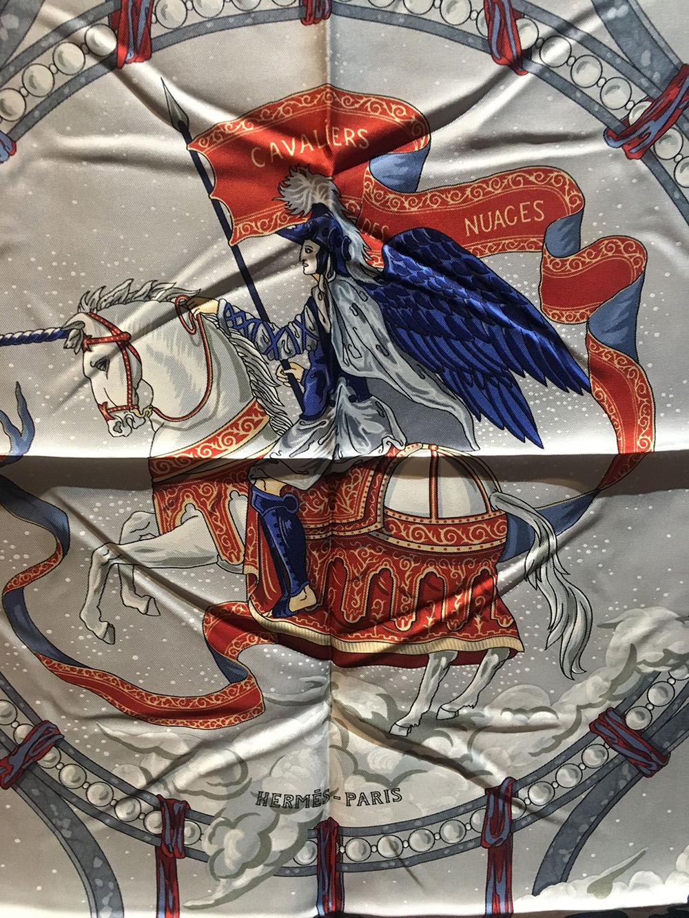 Authentic Hermes Cavaliers des Nuages silk scarf in gray in excellent condition. Original silk screen design c1999 by Jean-Christophe Donnadieu depicts a wonderful mythological story over a gray background set in the stars. 100% silk, hand rolled
