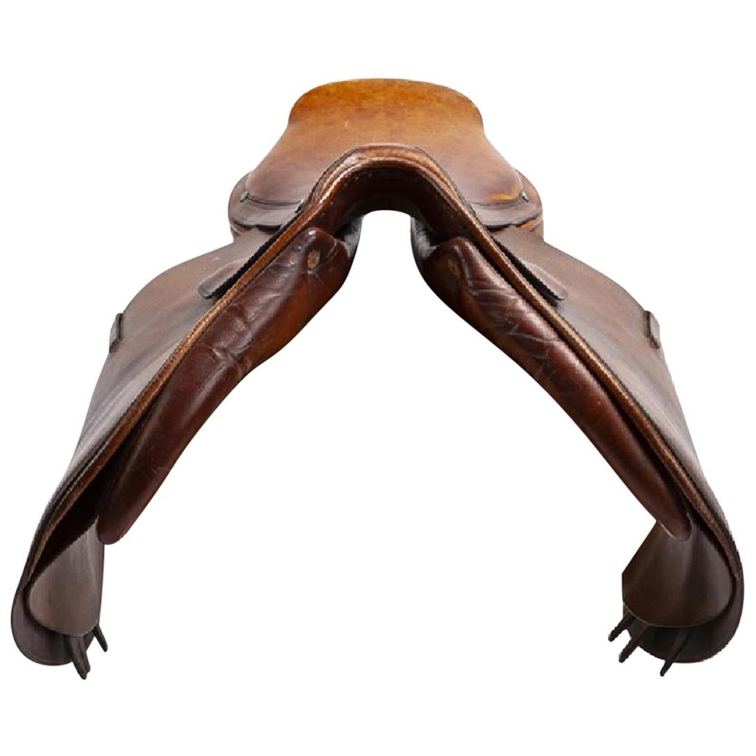 Hermes vintage leather saddle. Brown hue with adjustable buckles. The silver rivets are marked 