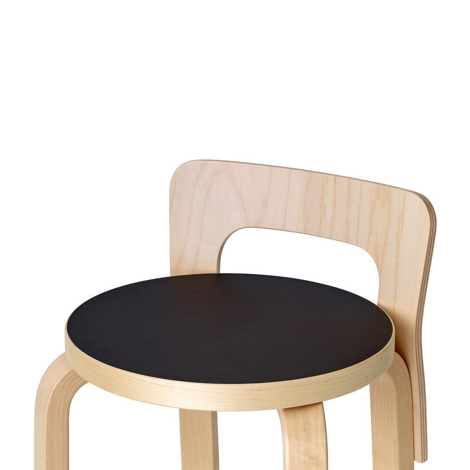 Authentic high chair K65 in birch with linoleum seat by Alvar Aalto & Artek. Combining the best elements of both a stool and a chair, Alvar Aalto's high chair K65 is perfectly proportioned for counter-height seating. The molded birch plywood