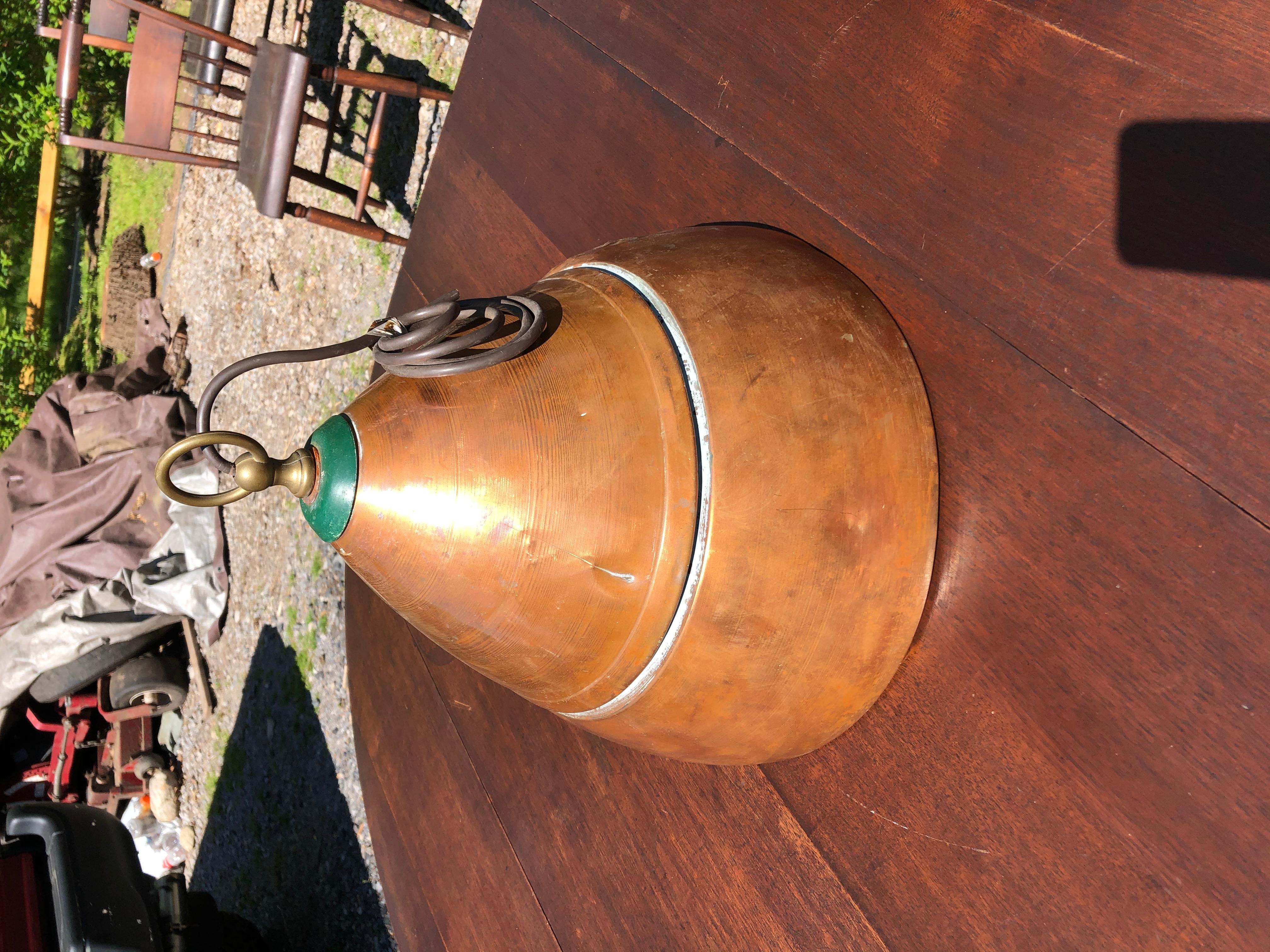 A wonderful vintage slightly distressed copper industrial dome shaped light fixture having green cap and brass circular hook as well as white enamel lining.
As is. Requires rewiring.