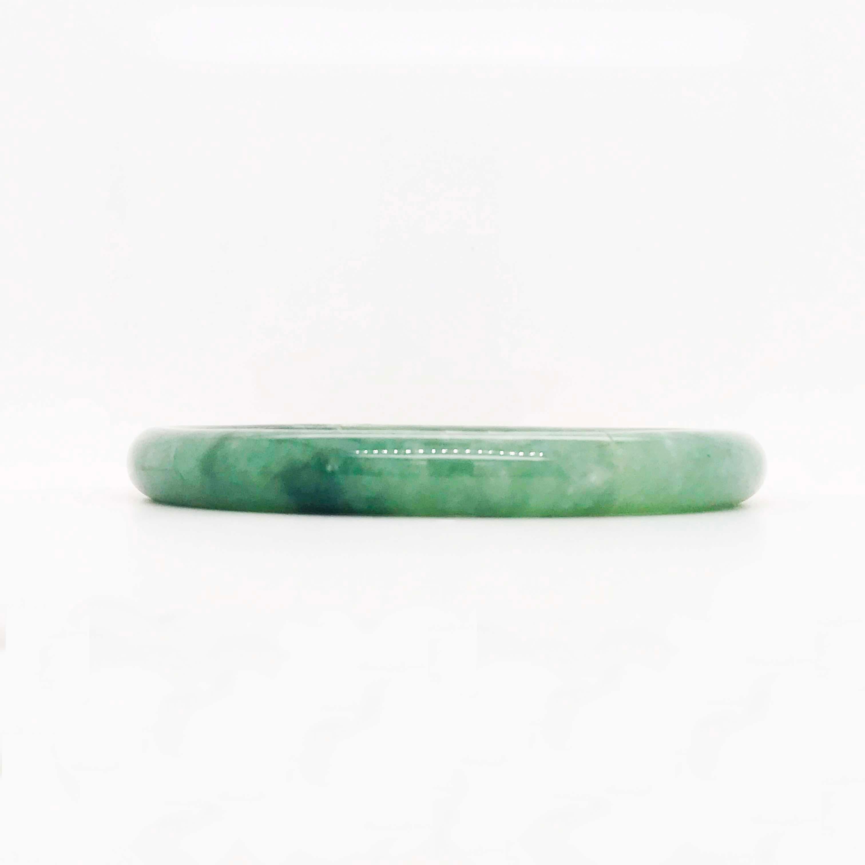This natural, authentic jade bangle bracelet has beautiful molten dark to light green colors. It would be a joy to wear as jade is known for its protective and positive properties!  There are two types of jade-nephrite and jadeite. Jadeite jade is