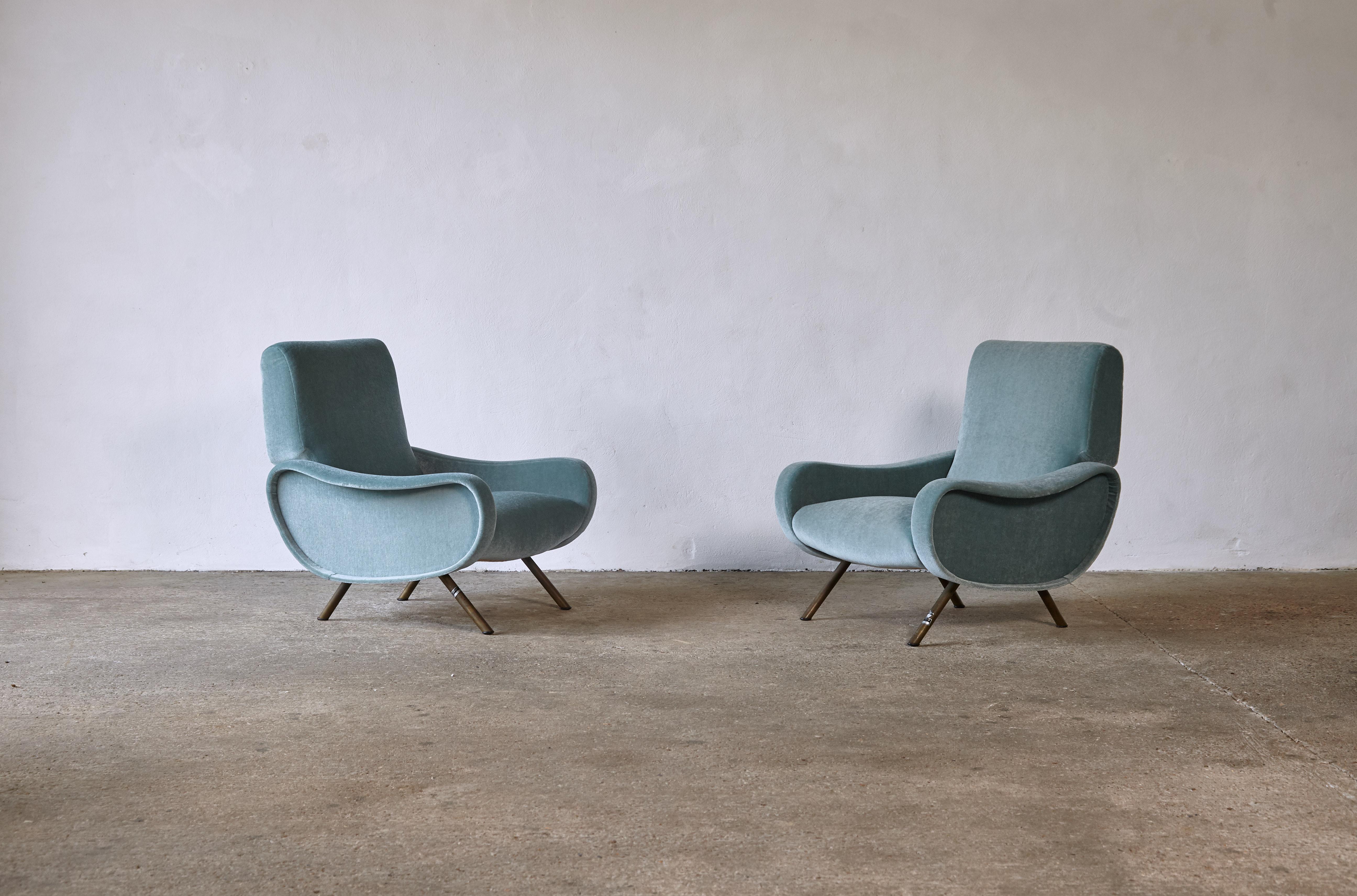 A pair of original and authentic early Marco Zanuso lady chairs, Arflex, Italy, 1950s. Newly reupholstered in a high quality 100% mohair pile in pale blue (with a very subtle hint of green...almost turquiose). Brass feet with original natural